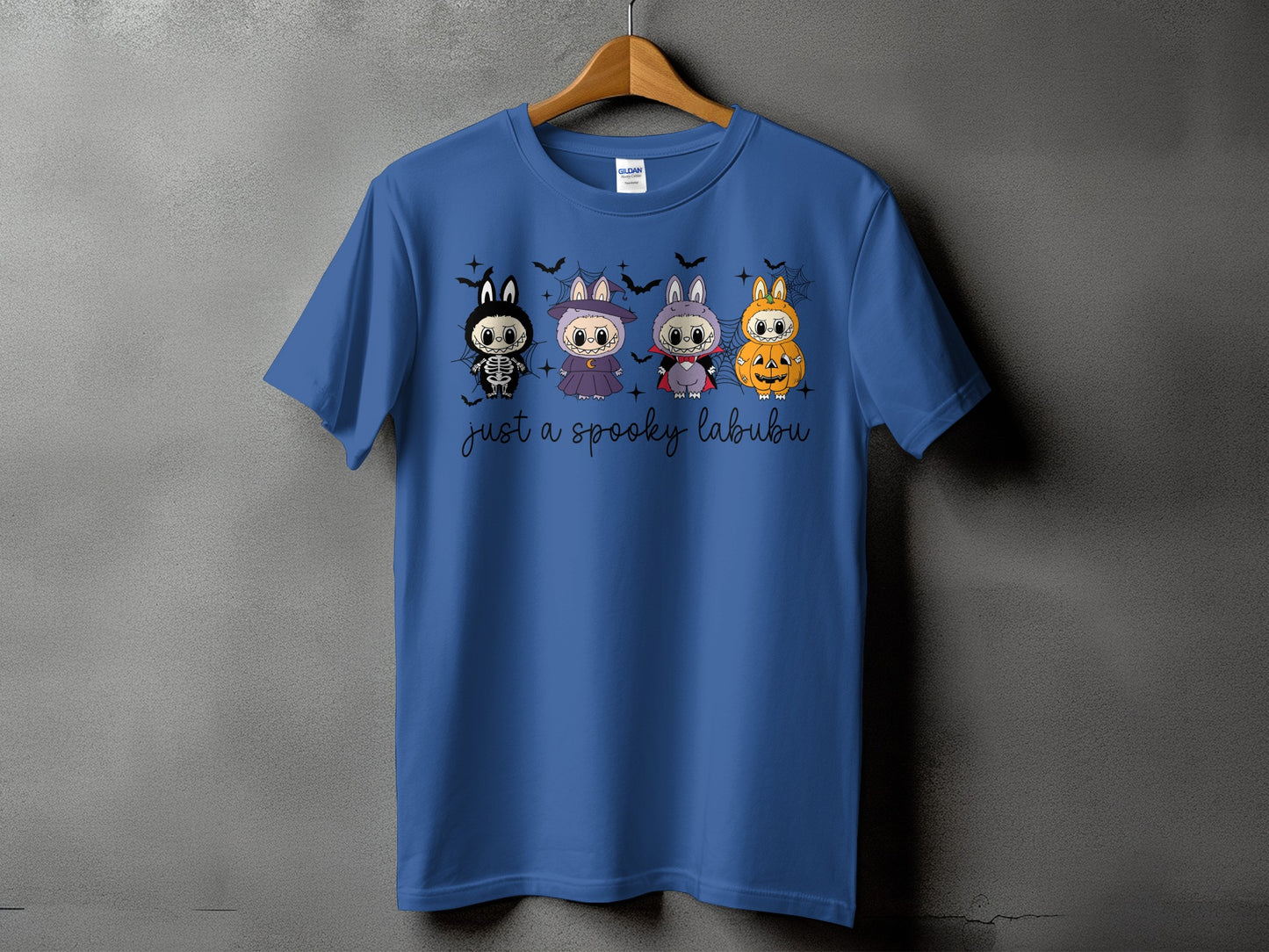 Blue t-shirt with "just a spooky labubu" text and four Halloween-themed characters.
