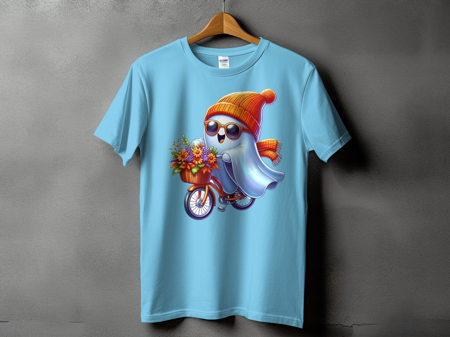 Light blue t-shirt featuring a cartoon ghost on a bicycle with flowers.