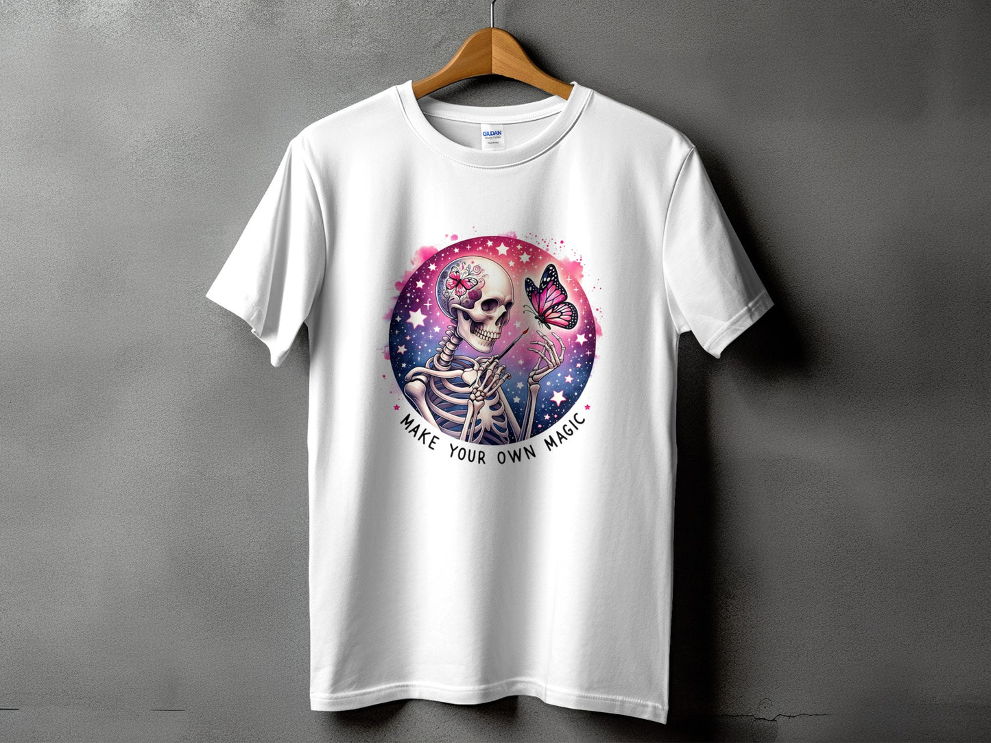 White t-shirt with skeleton and butterfly graphic saying "Make Your Own Magic."