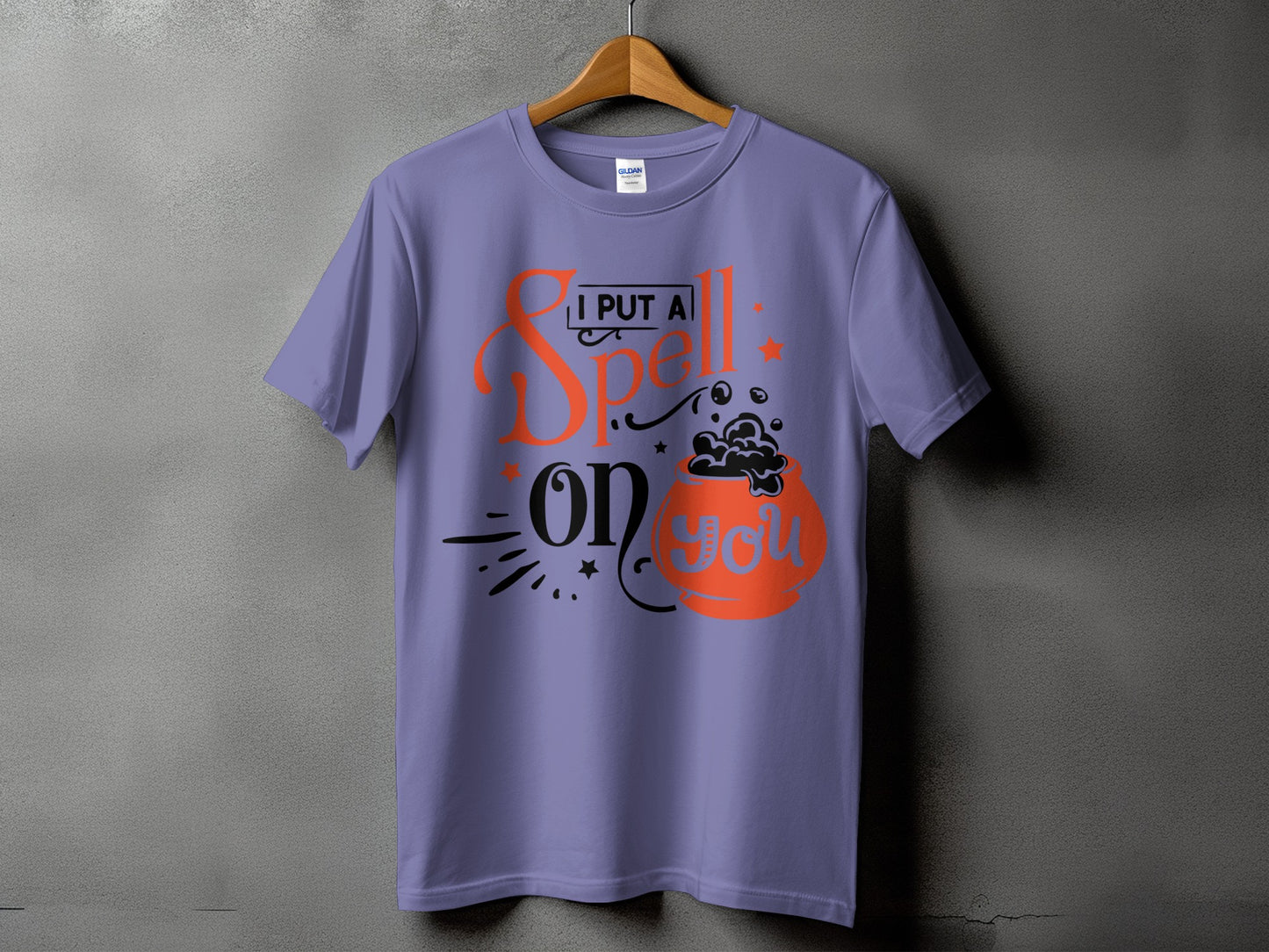 Purple t-shirt with text "I PUT A Spell on you" and cauldron graphic.
