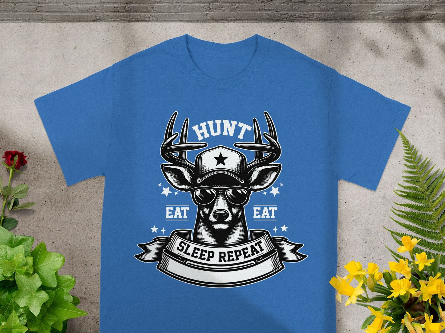 Blue t-shirt with deer wearing cap, sunglasses, and graphic text: HUNT, EAT, SLEEP REPEAT.