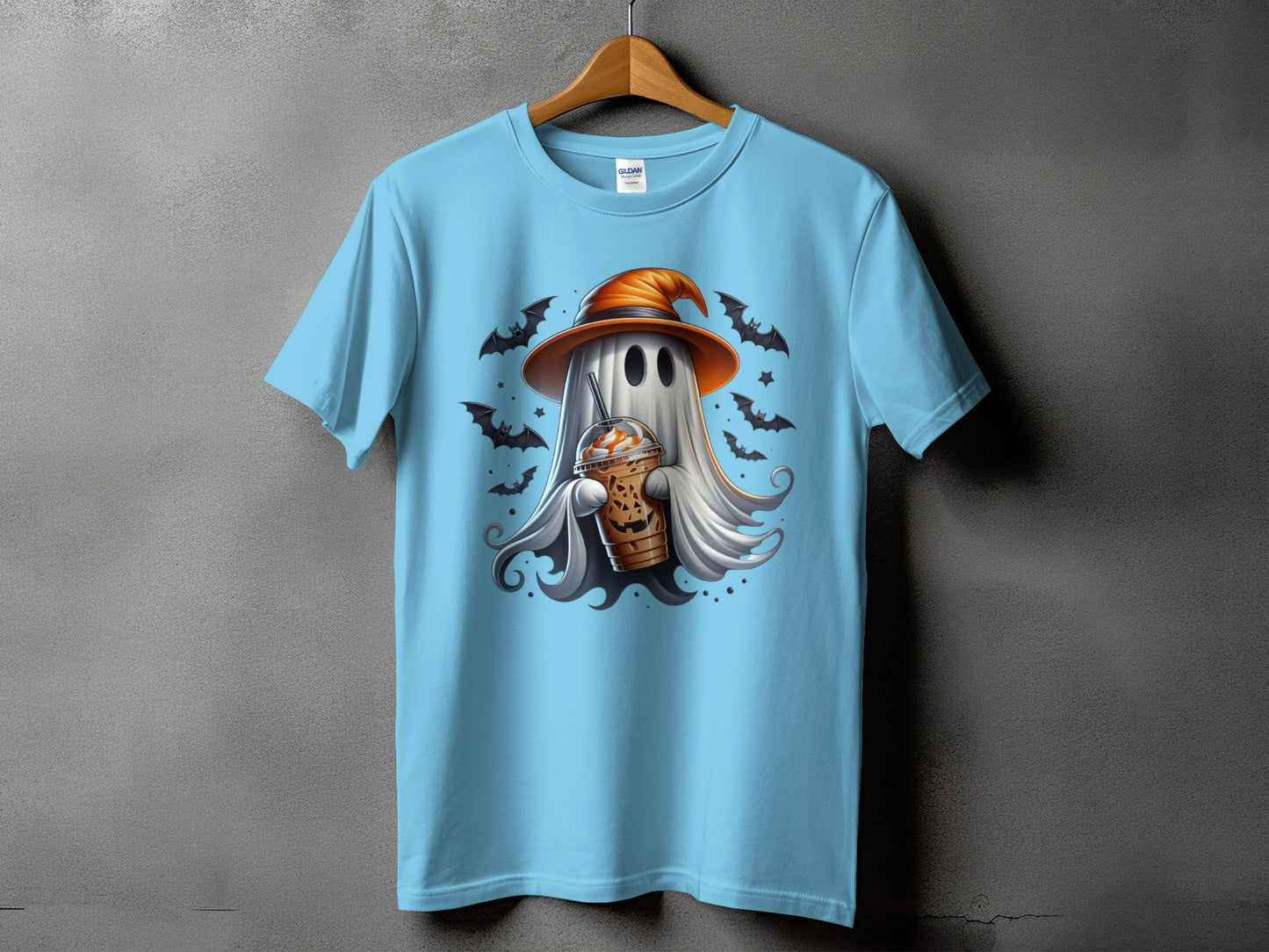 Ghost wearing witch hat holding Halloween coffee cup with bats and stars design on blue shirt.