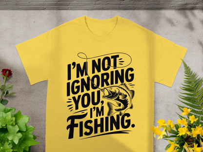 Yellow t-shirt with black text reading "I'm Not Ignoring You, I'm Fishing."