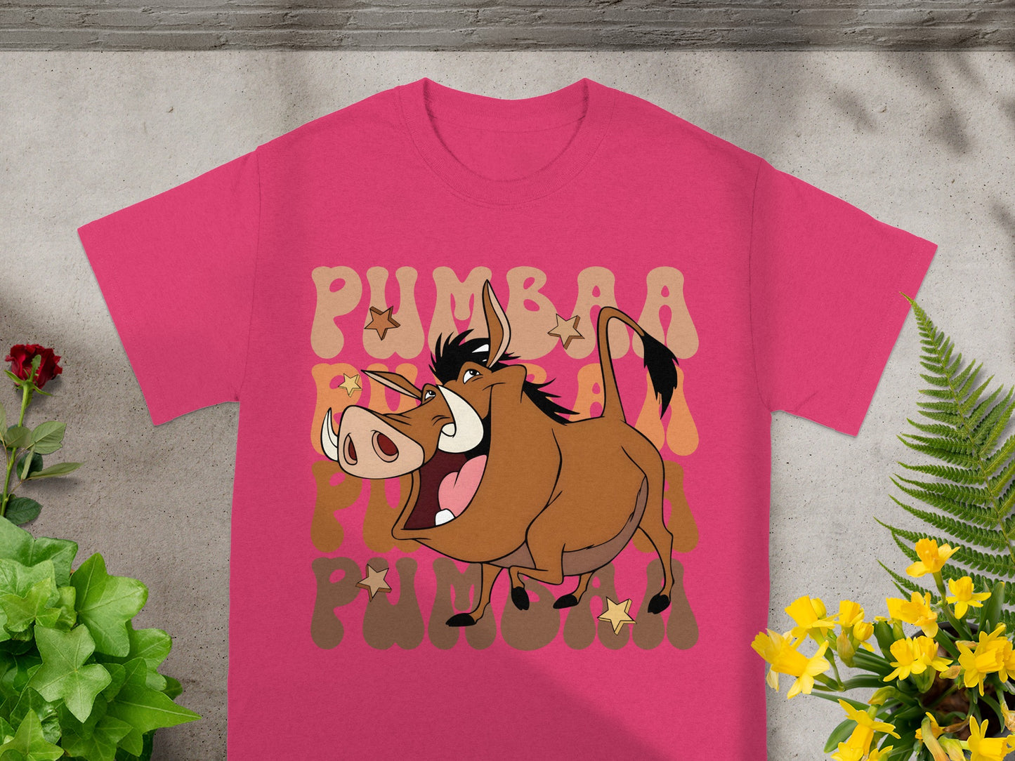 Pink t-shirt with Pumbaa from The Lion King graphic and text.