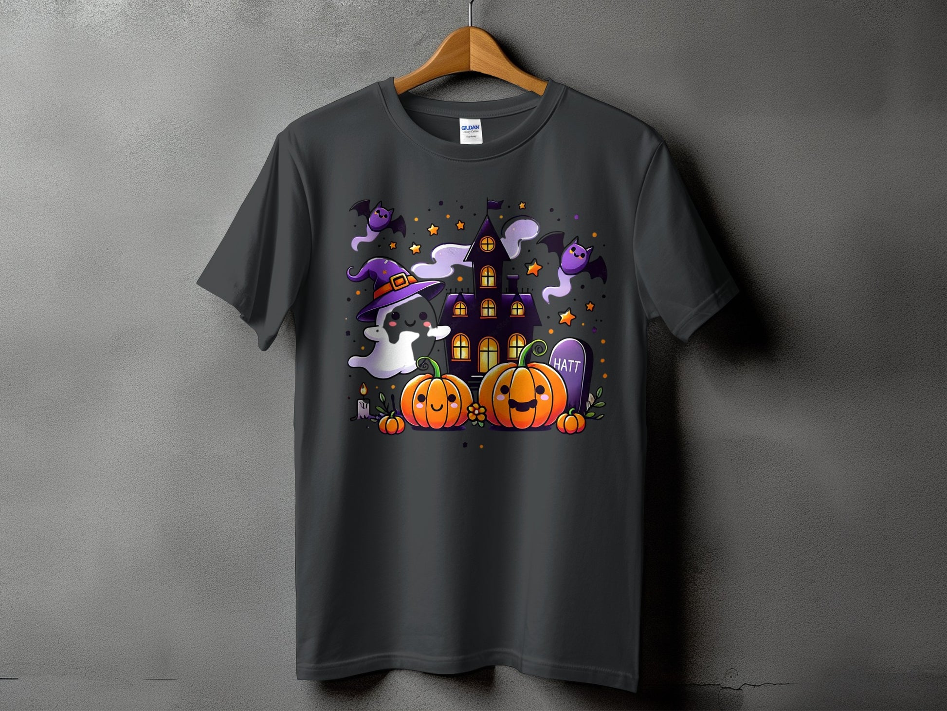 Dark grey t-shirt with a Halloween-themed graphic featuring pumpkins, ghosts, bats, and a haunted house.