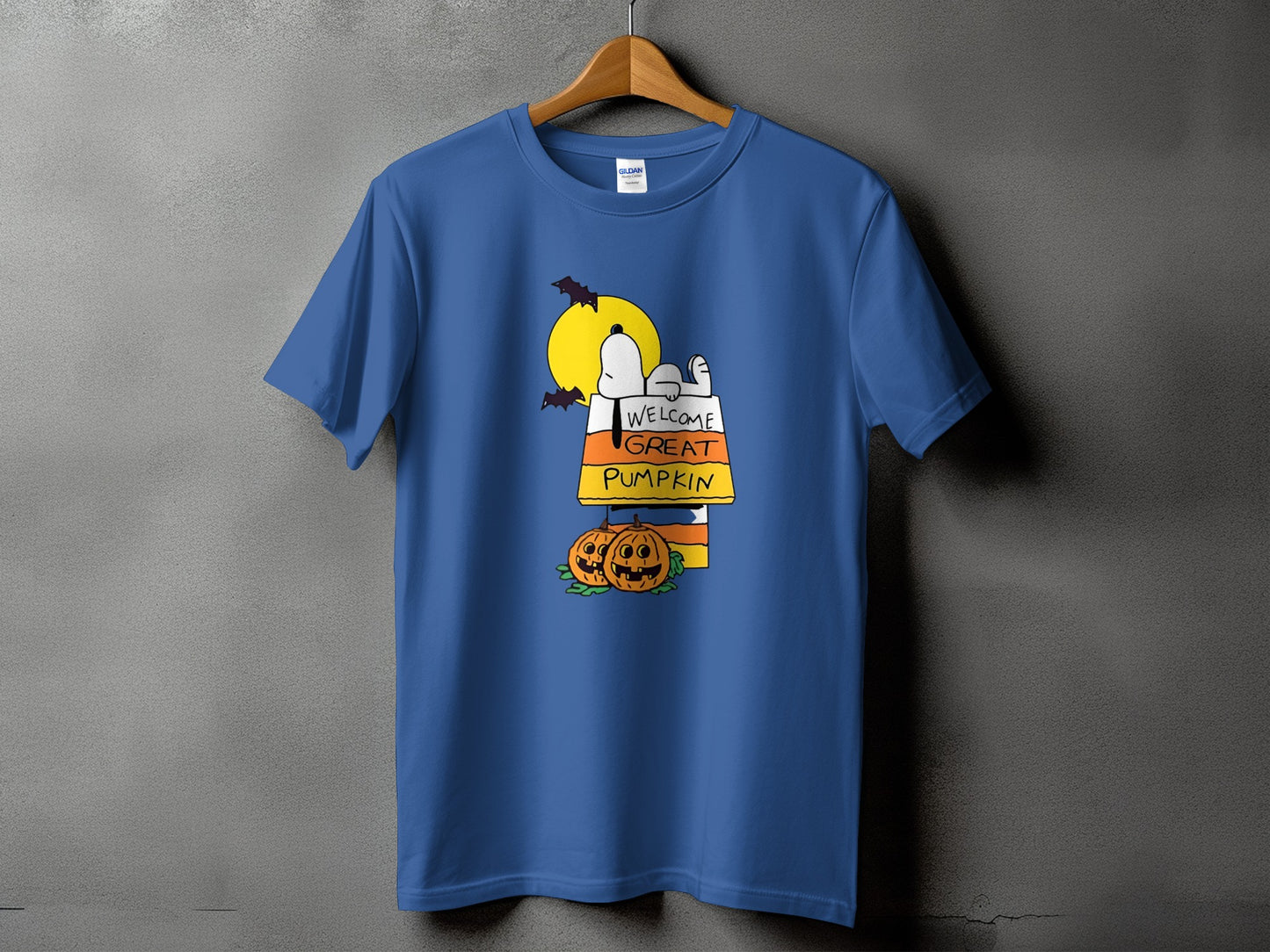 Snoopy wearing candy corn, with pumpkins and bats under a full moon.