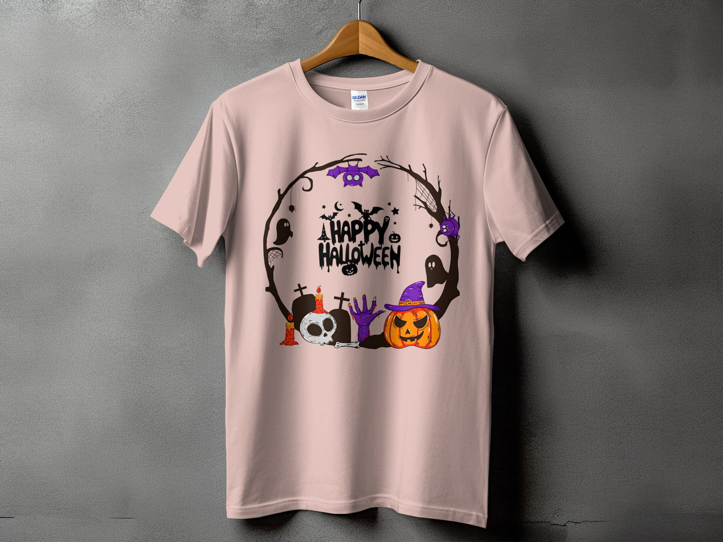 Light pink t-shirt with a circular Halloween graphic featuring a pumpkin, skull, and bats.