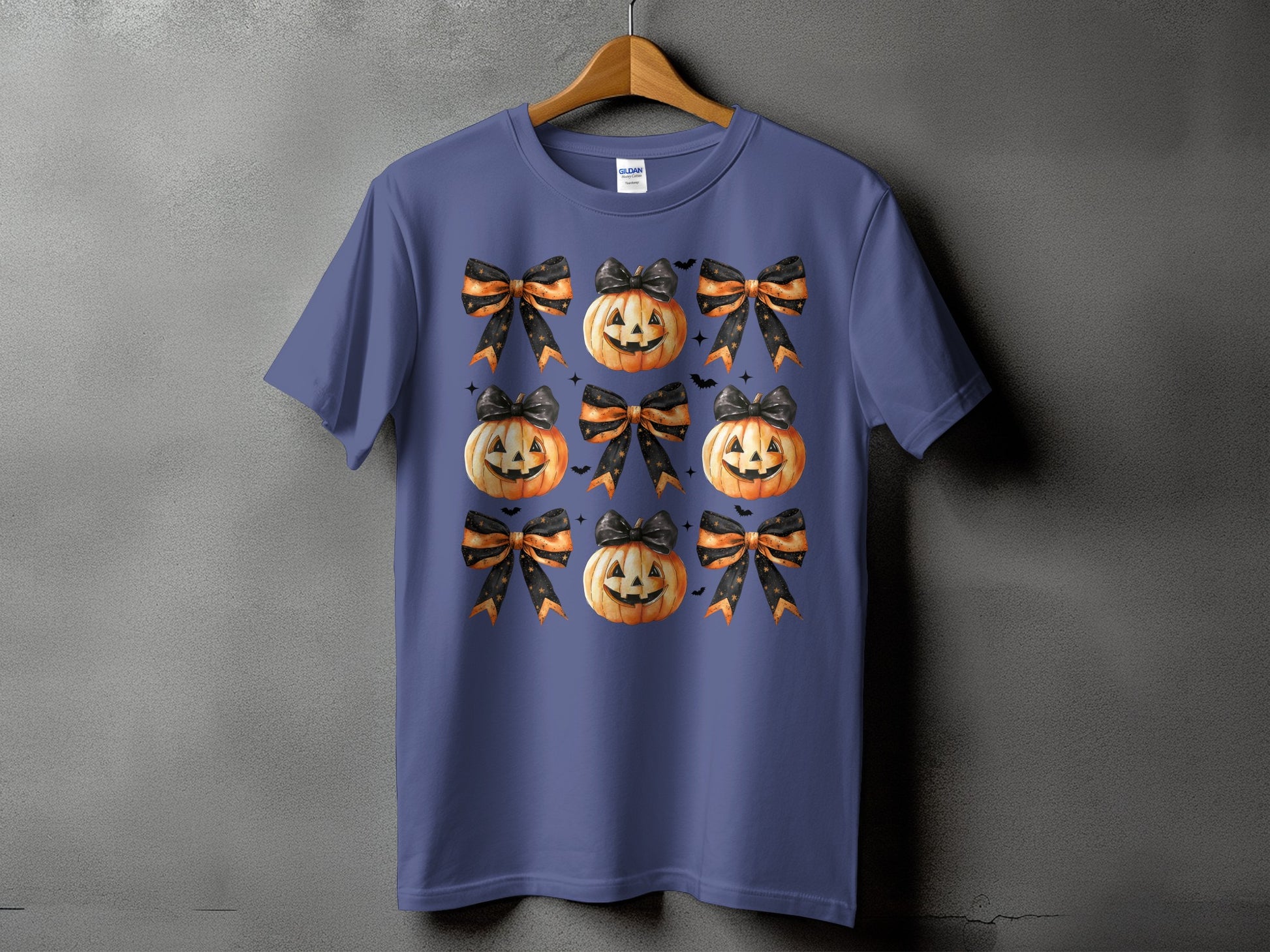 Purple t-shirt with a repeating pattern of jack-o'-lanterns and Halloween bows.