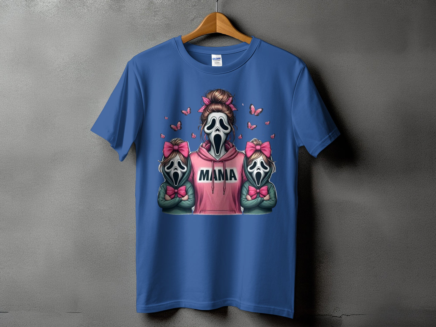 Blue t-shirt with "Mama" text and ghost-faced figures with pink bows.