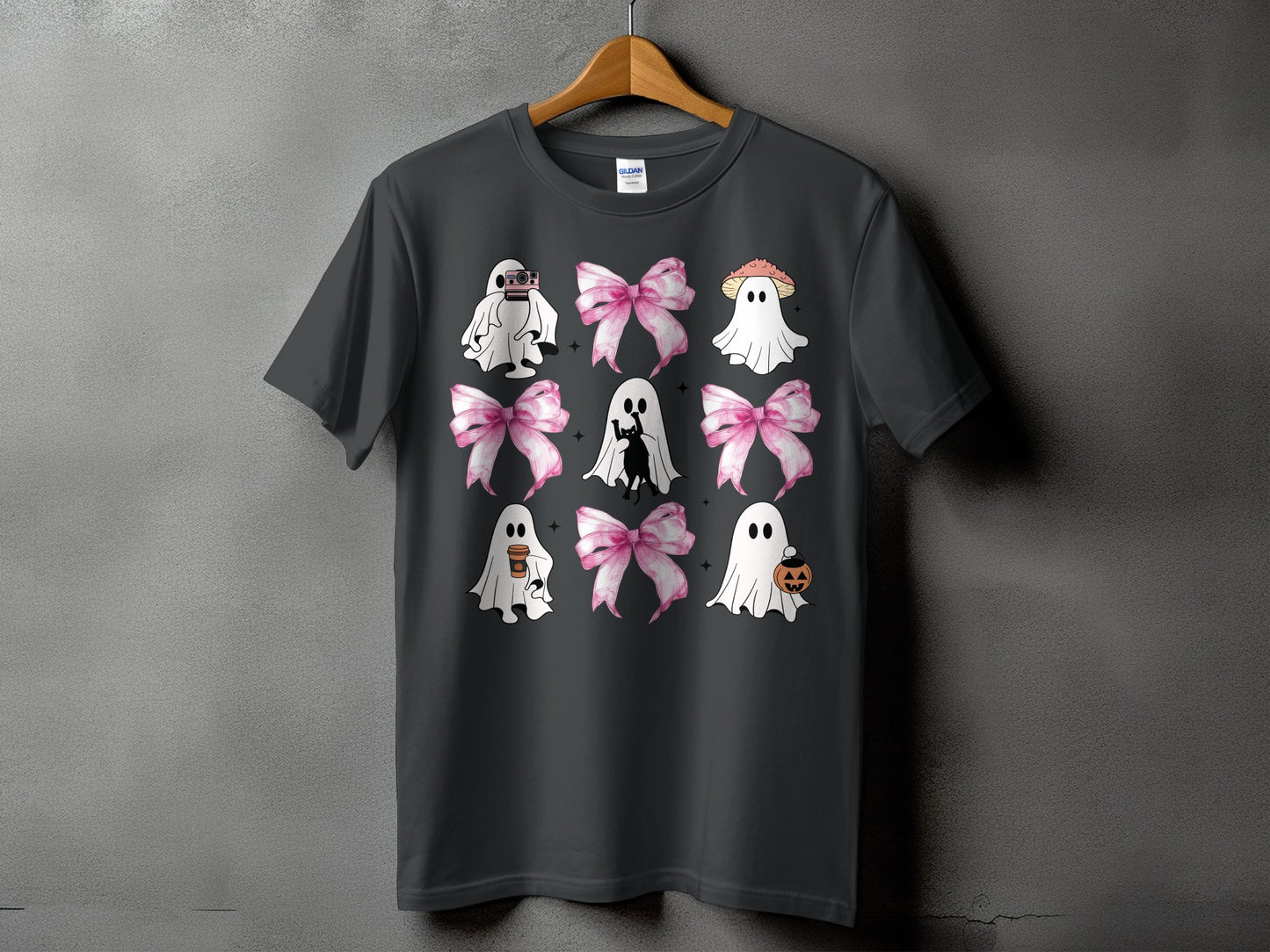 Dark gray t-shirt with a grid of cartoon ghosts, bows, and Halloween icons.