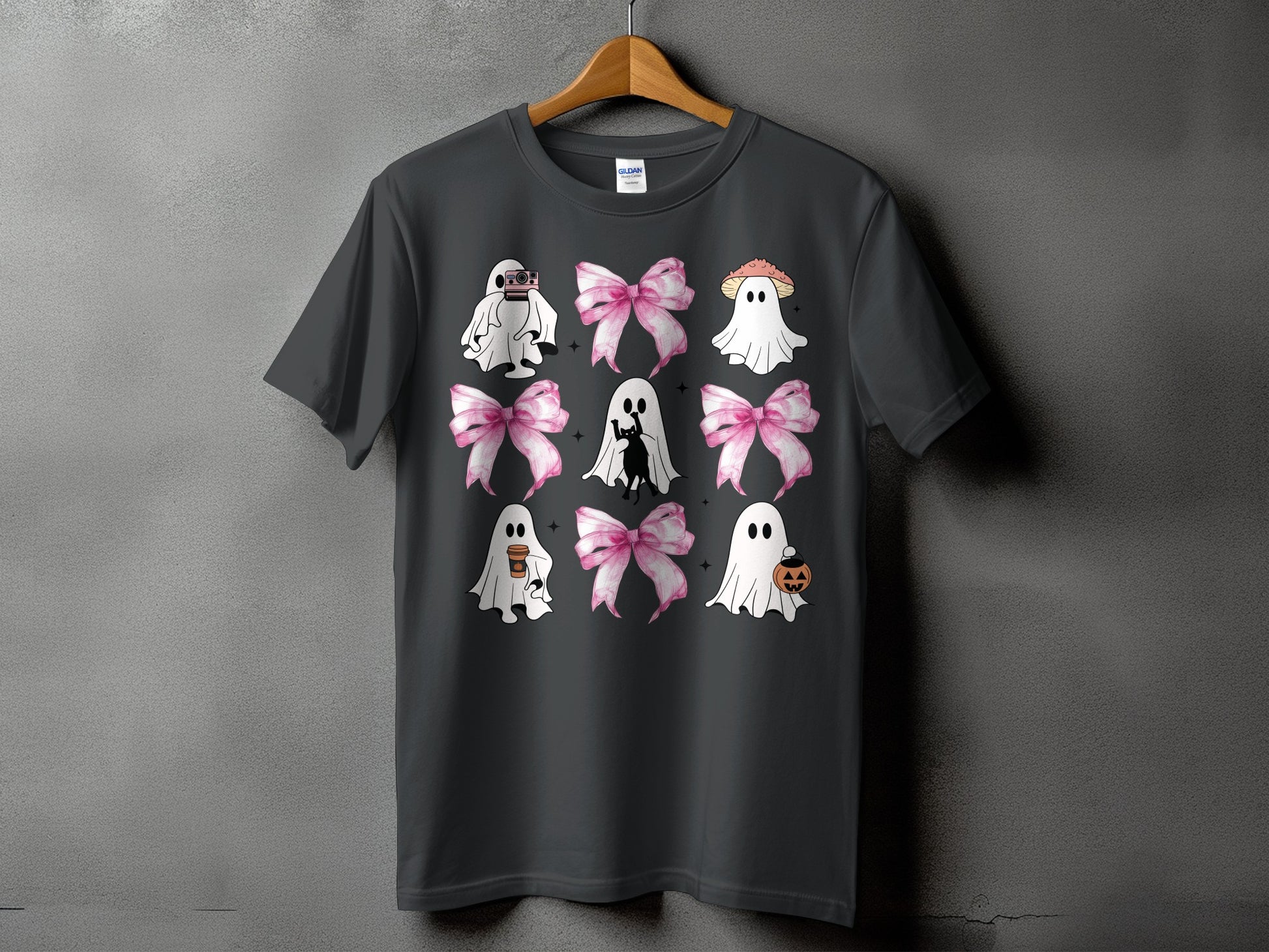 Dark gray t-shirt with a grid of cartoon ghosts, bows, and Halloween icons.