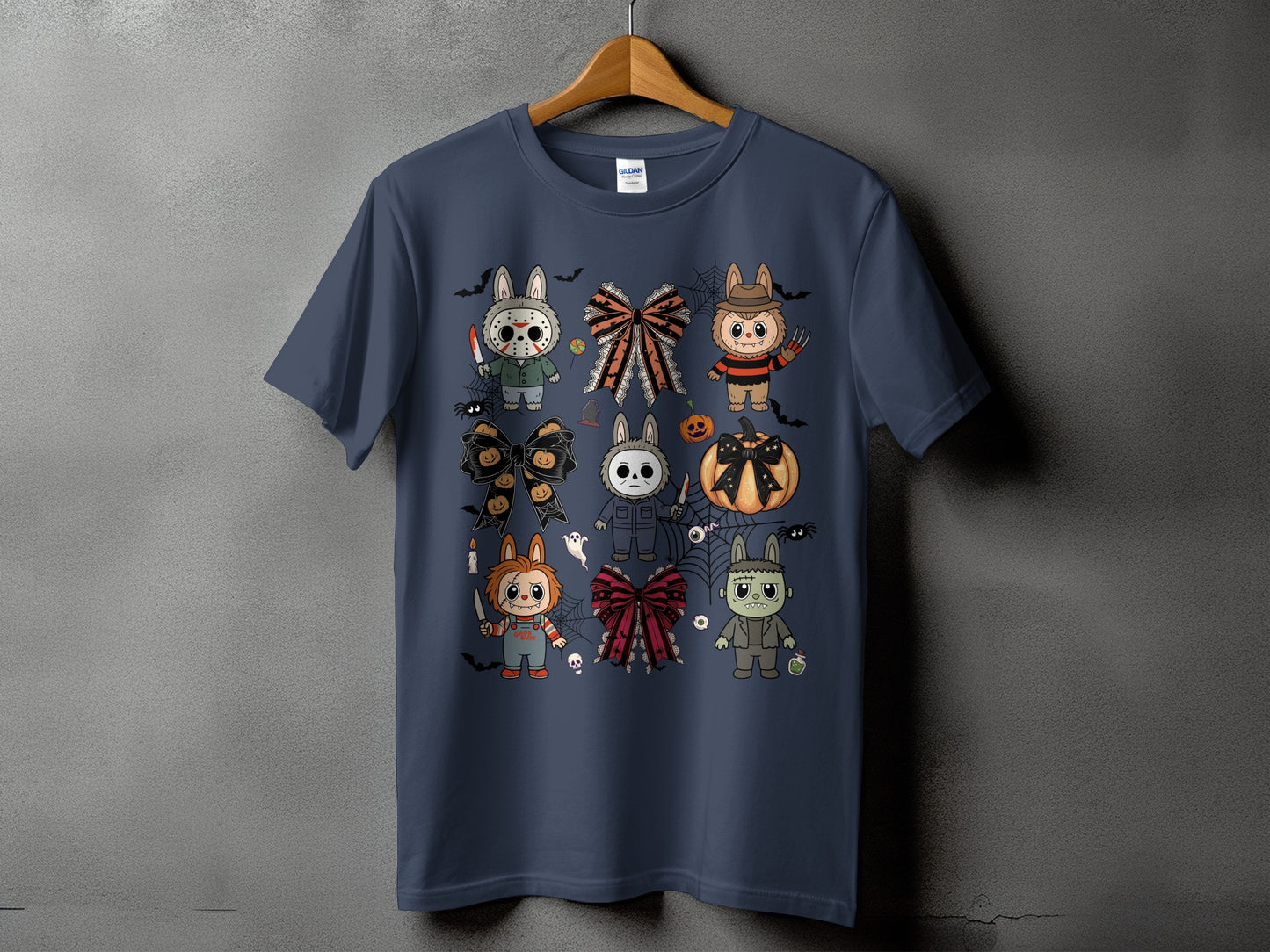 Dark navy t-shirt with Halloween-themed cartoon characters and bows arranged in a grid.