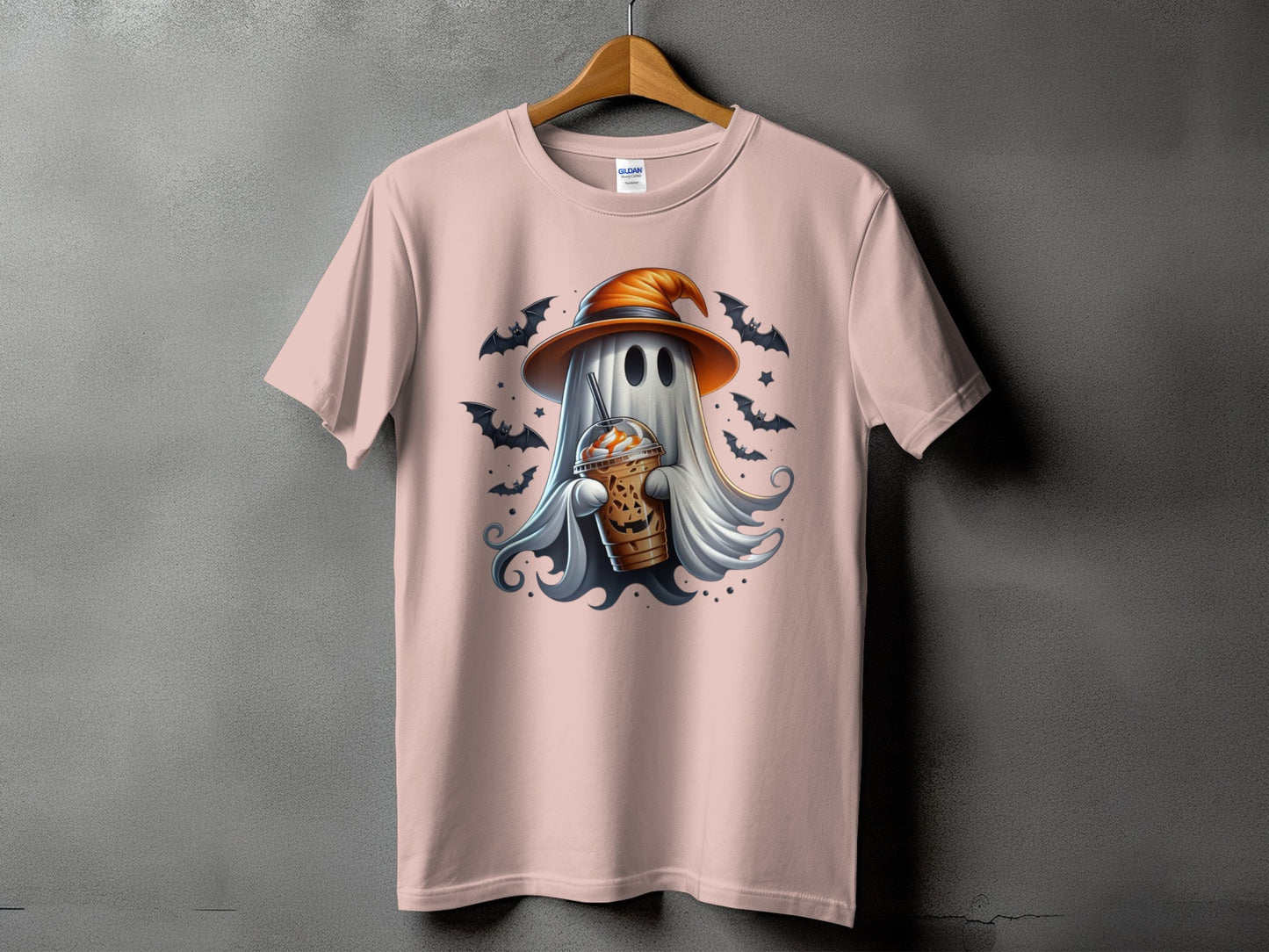 Pink t-shirt with a ghost wearing a witch hat holding a pumpkin spice latte.