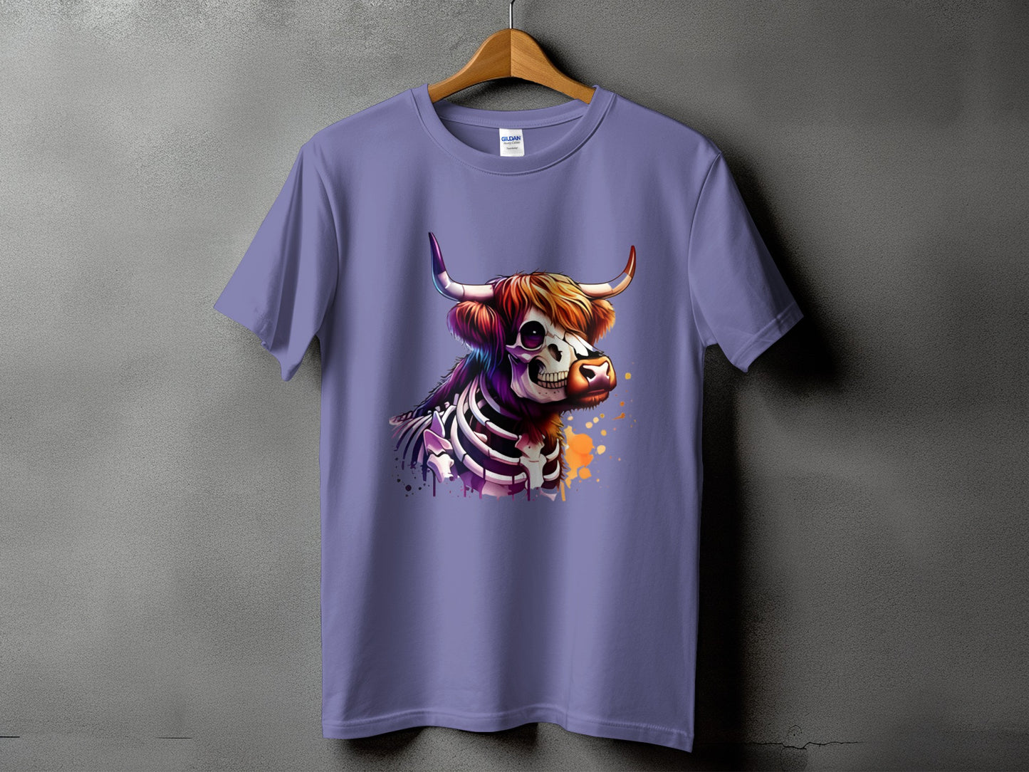 T-shirt with a skeleton Highland cow graphic and colorful paint splatters.