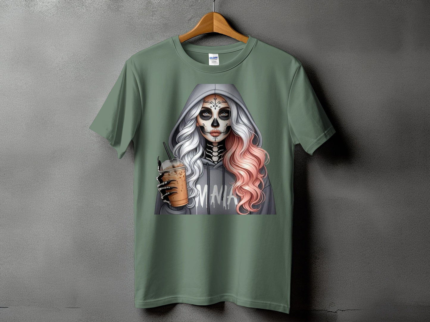 Skull-faced woman in hoodie holding iced coffee, "MMA" text on hoodie.