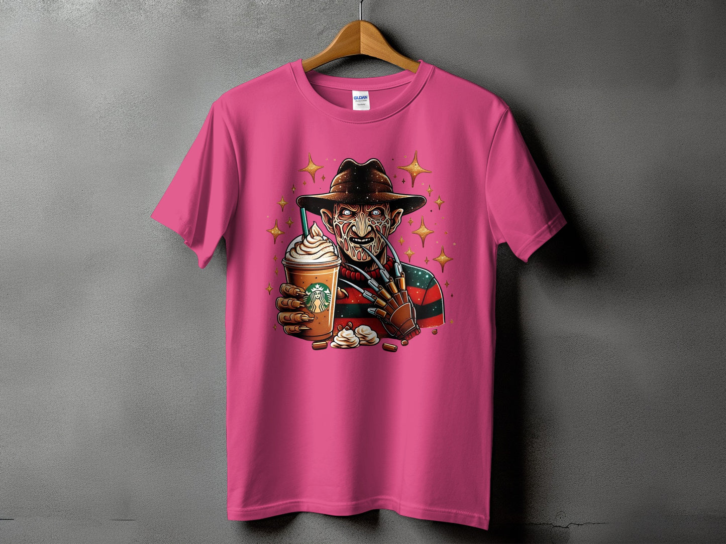 Freddy Krueger holds a Starbucks Frappuccino with whipped cream on a pink t-shirt.