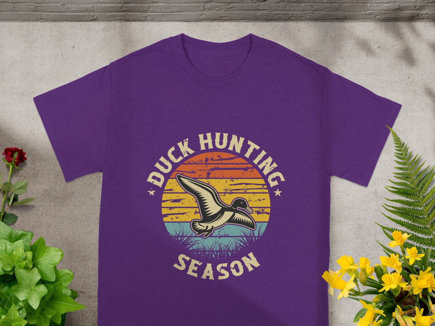 Purple t-shirt with "Duck Hunting Season" text and flying duck graphic.