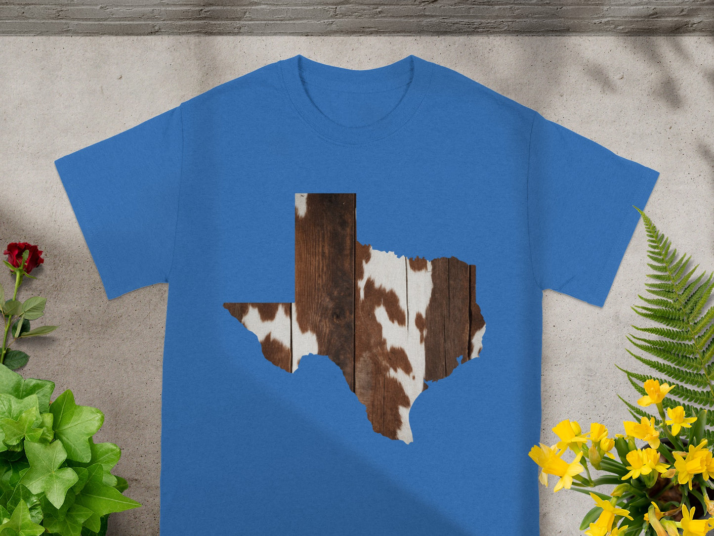 Blue t-shirt with Texas map cutout filled with wood and cowhide texture.