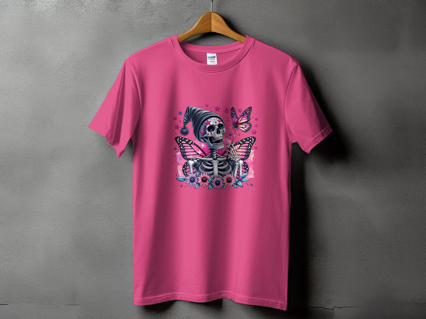 Pink t-shirt with skeleton, butterflies, and floral graphic design.