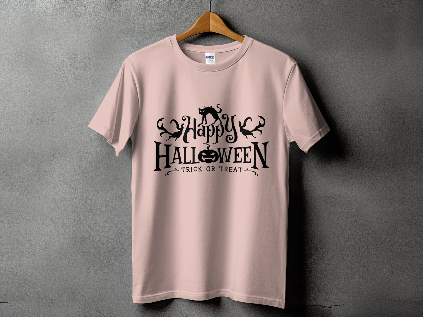 Pink t-shirt with black Halloween graphic featuring a cat, pumpkin, and text.