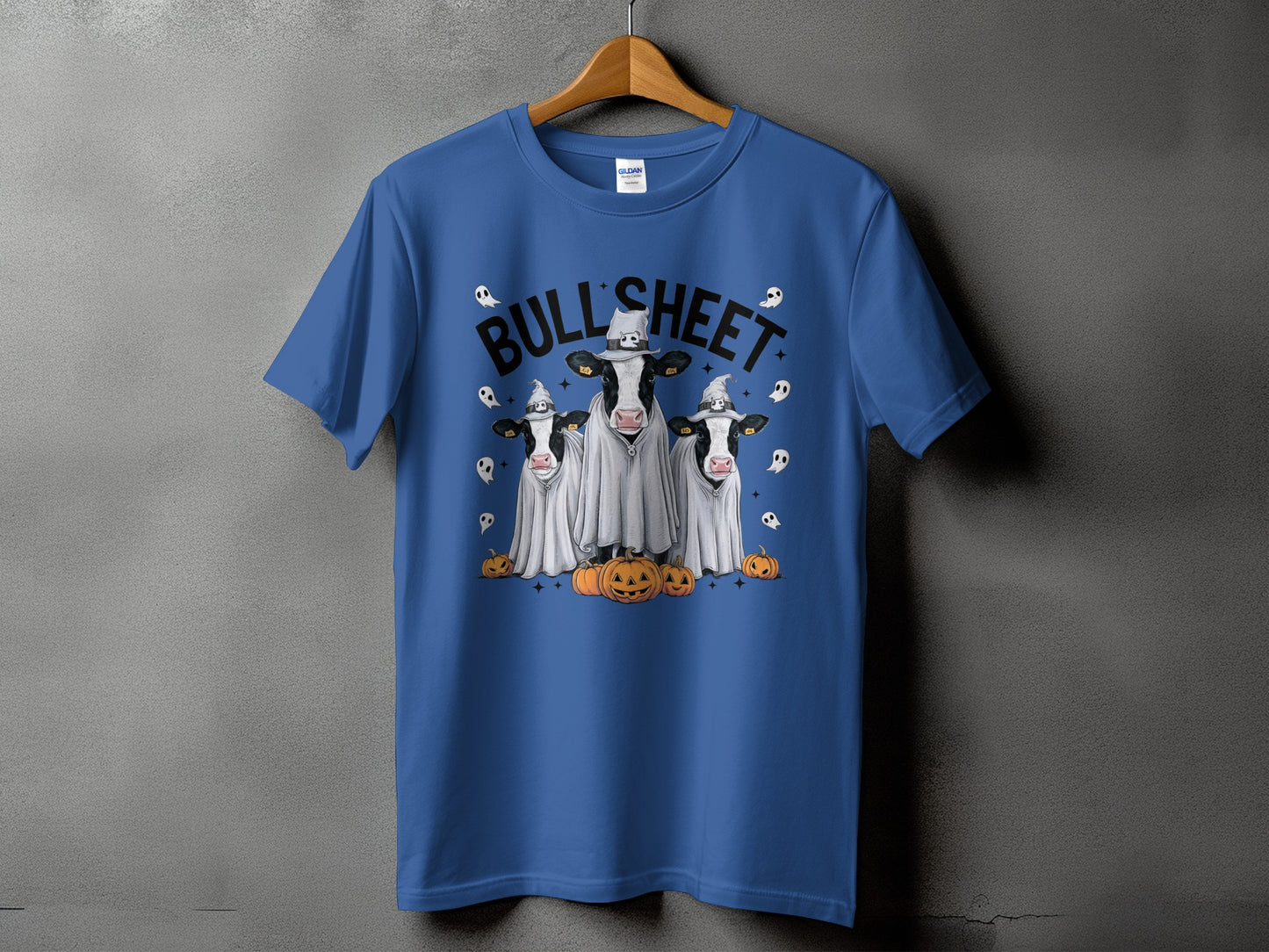 Blue t-shirt with "Bull'Sheet" text, three cows in ghost costumes, and pumpkins.