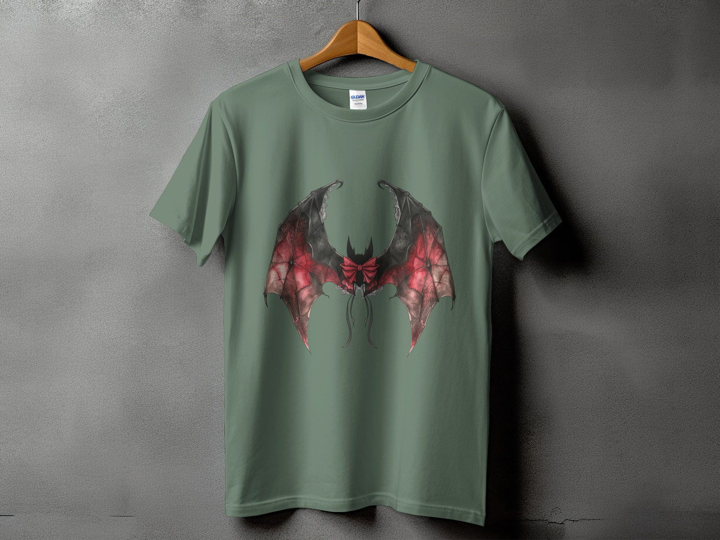 Green t-shirt with a detailed bat wing design featuring red and black colors.