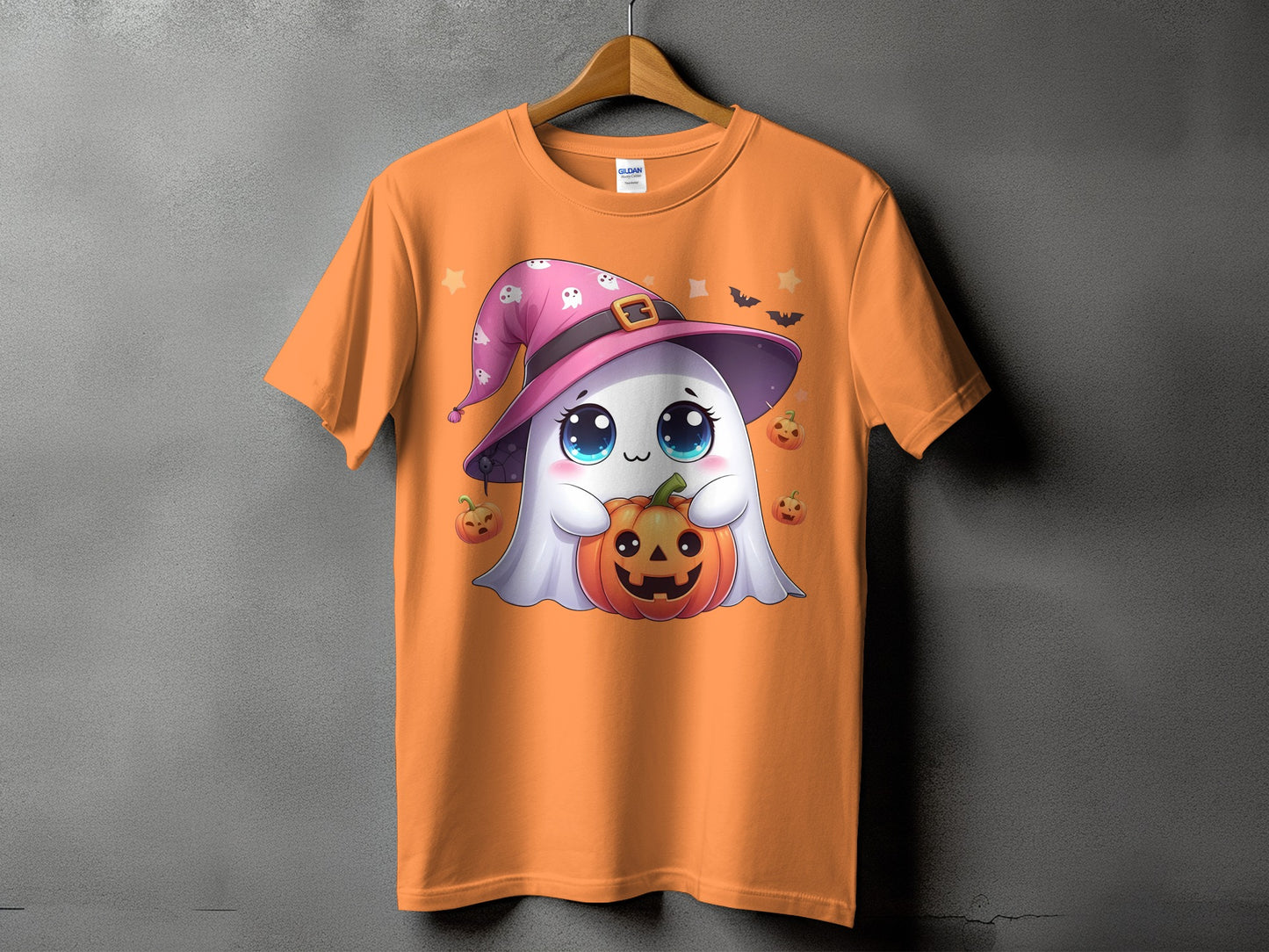 Orange t-shirt with a cartoon ghost in a witch hat holding a pumpkin.