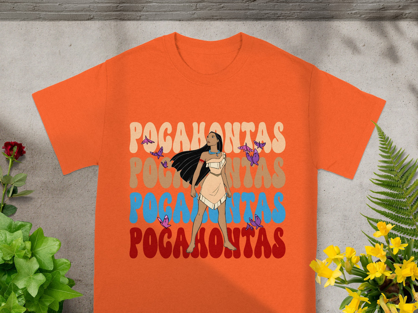 Orange t-shirt with "Pocahontas" text and a character illustration.