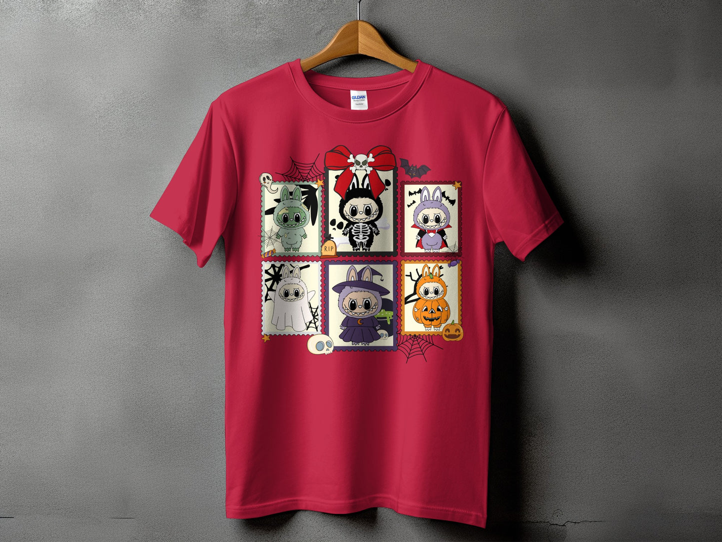 Crimson t-shirt with a collage of six Halloween-themed cartoon characters in stamp frames.