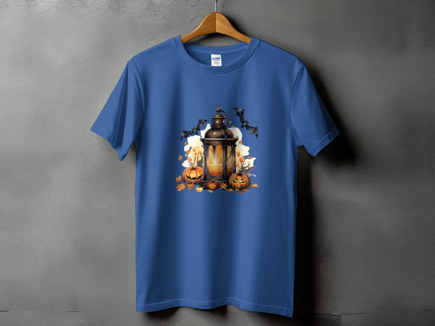 Blue t-shirt with a Halloween lantern, pumpkins, and bats graphic.