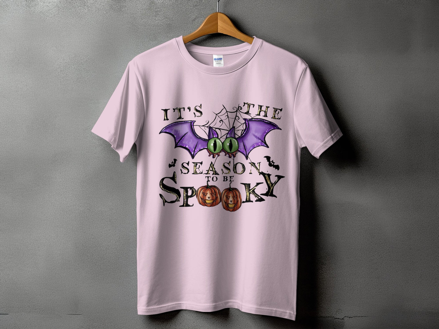Pink t-shirt with Halloween graphic: "It's the season to be spooky" with bat and pumpkins.