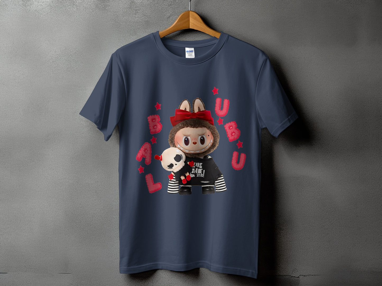 Dark blue t-shirt with cartoon character, skull plush, red bow, and bubble letters.
