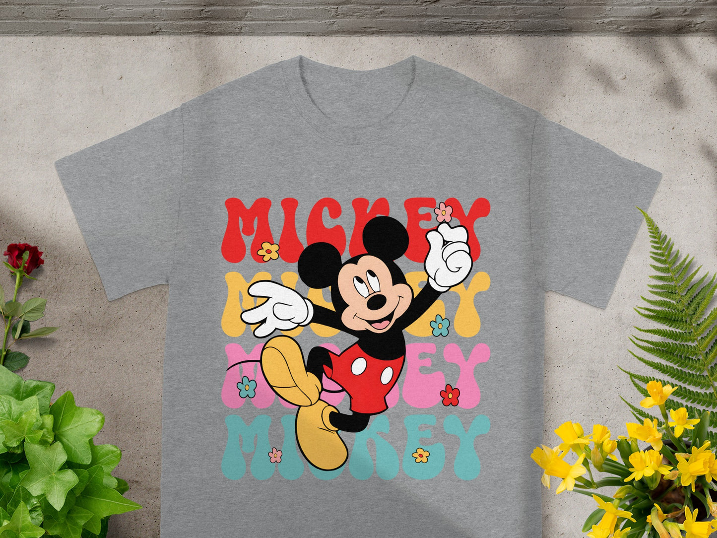 Mickey Mouse graphic t-shirt with colorful "Mickey" text and flowers.