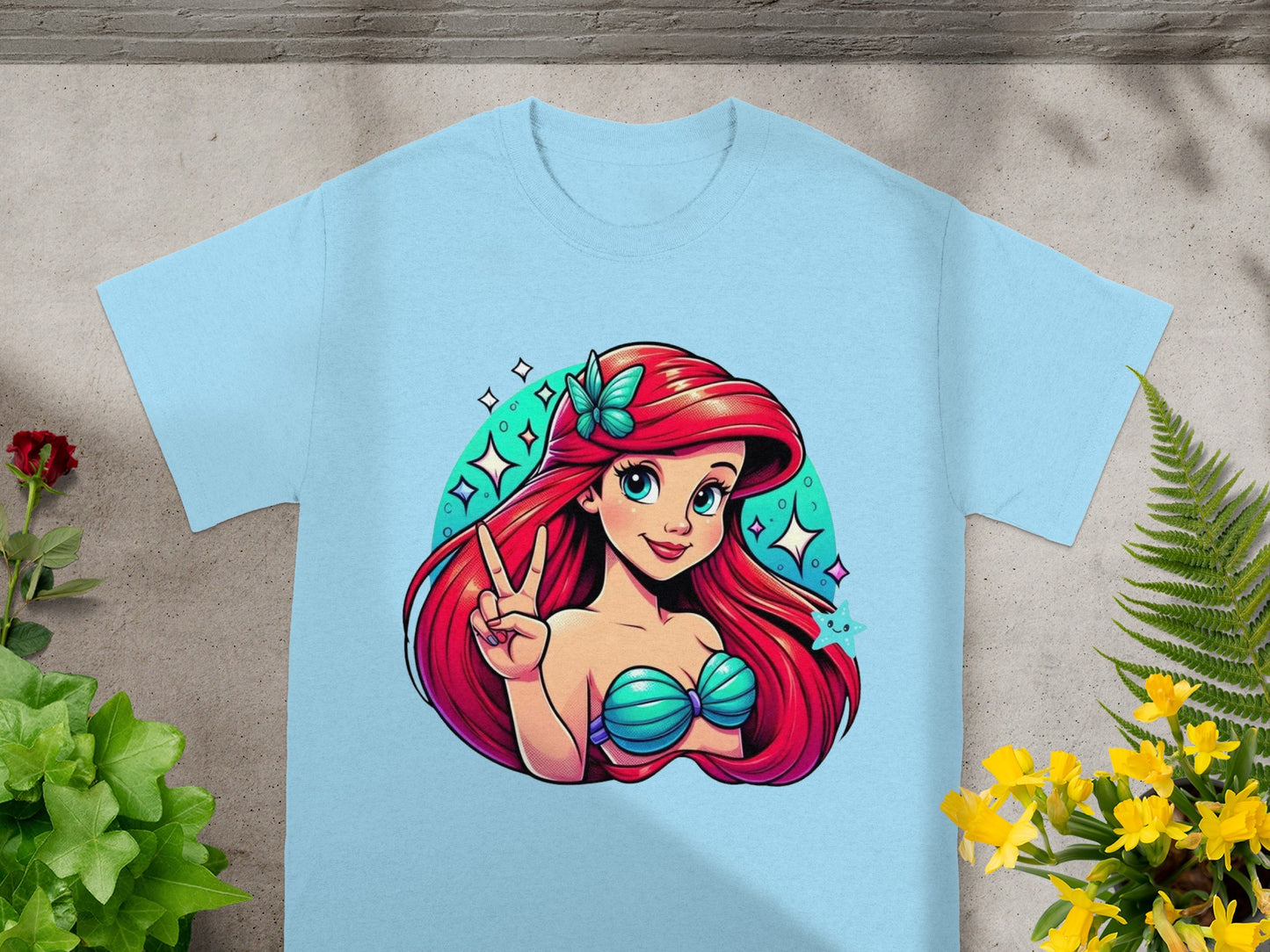 Light blue t-shirt with Ariel illustration making a peace sign.