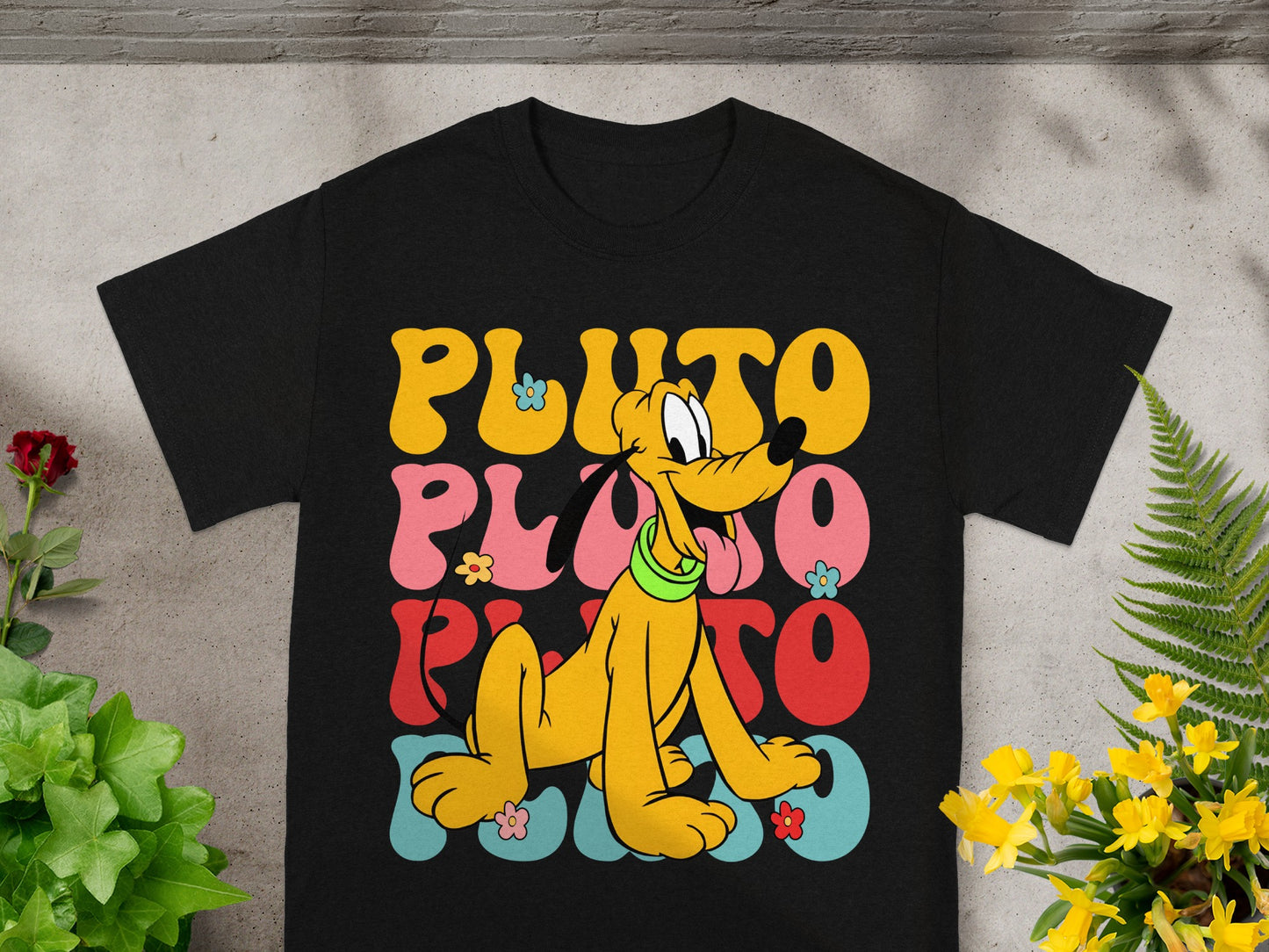 Black t-shirt with retro yellow, pink, and red "PLUTO" text and cartoon Pluto.