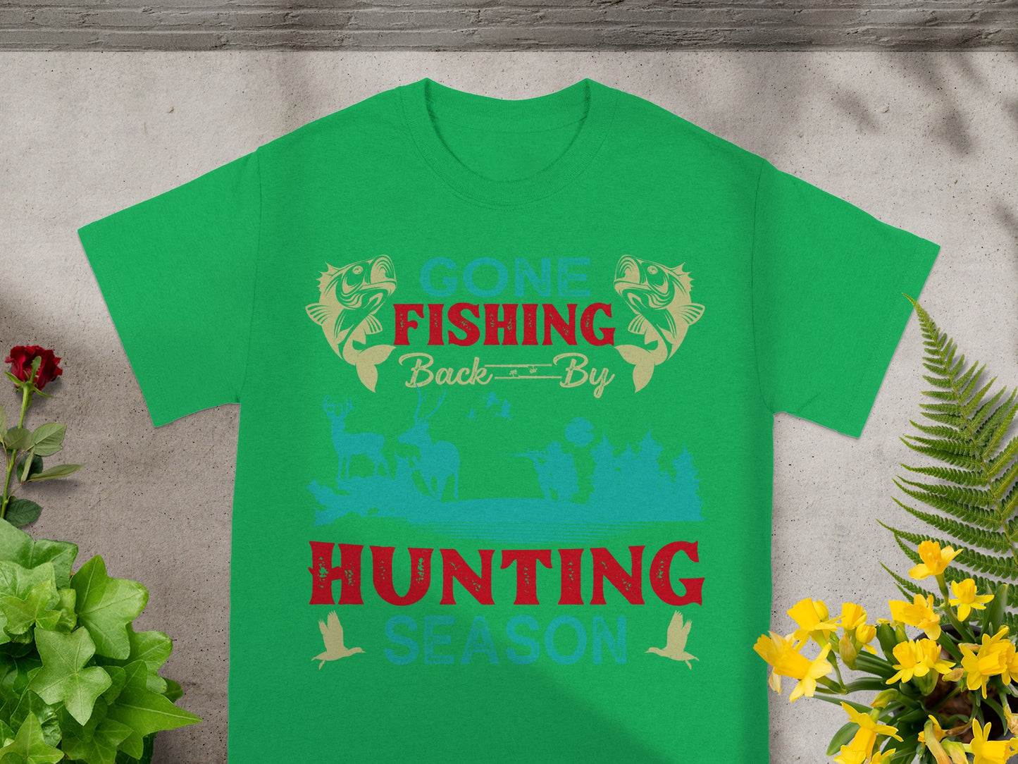 Green t-shirt with text "GONE FISHING BACK BY HUNTING SEASON" and outdoor graphics.