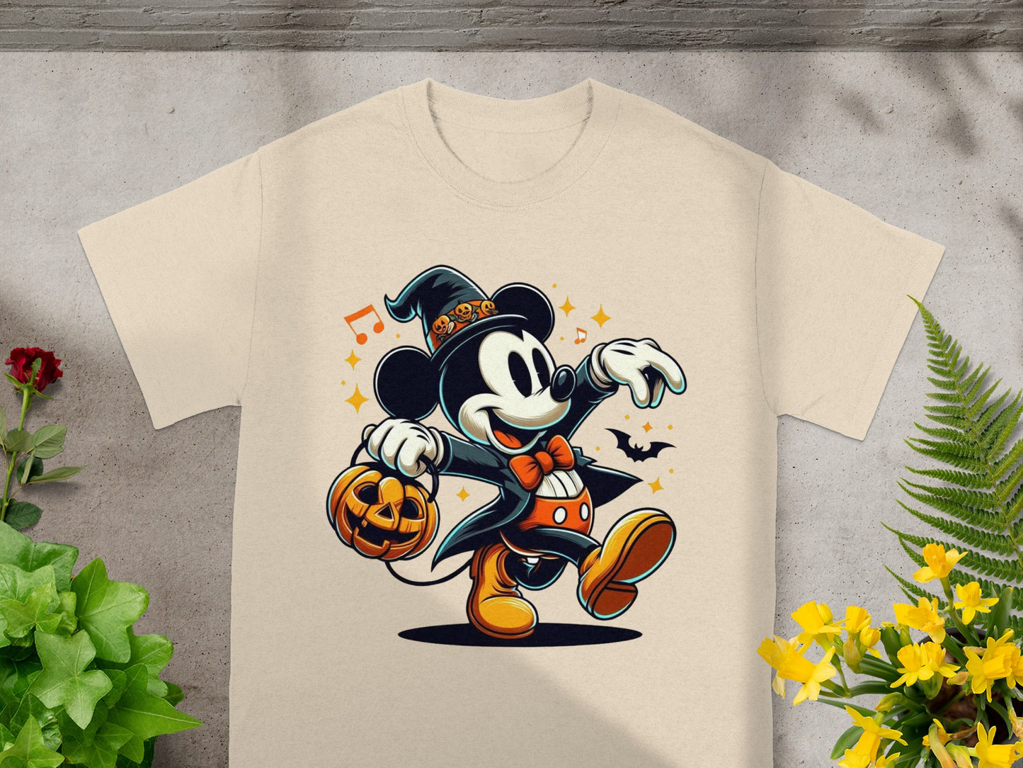 Mickey Mouse in Halloween costume carrying a jack-o'-lantern on a light tan t-shirt.
