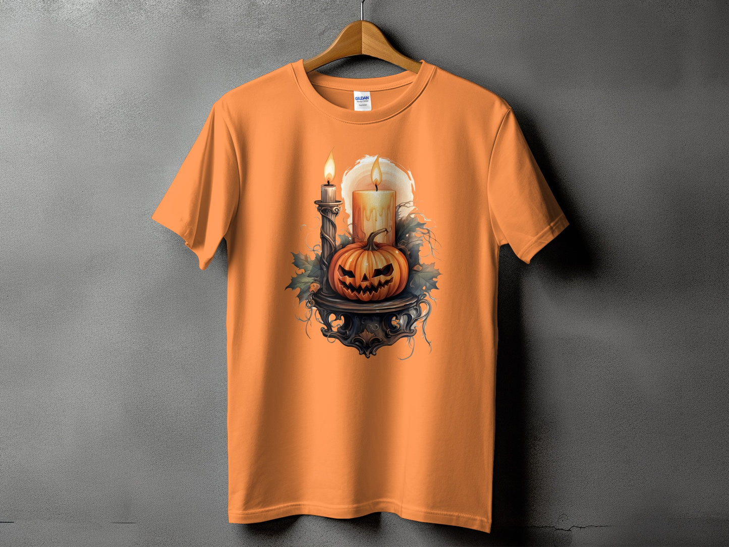 Orange t-shirt with Halloween graphic featuring a jack-o'-lantern and candles.