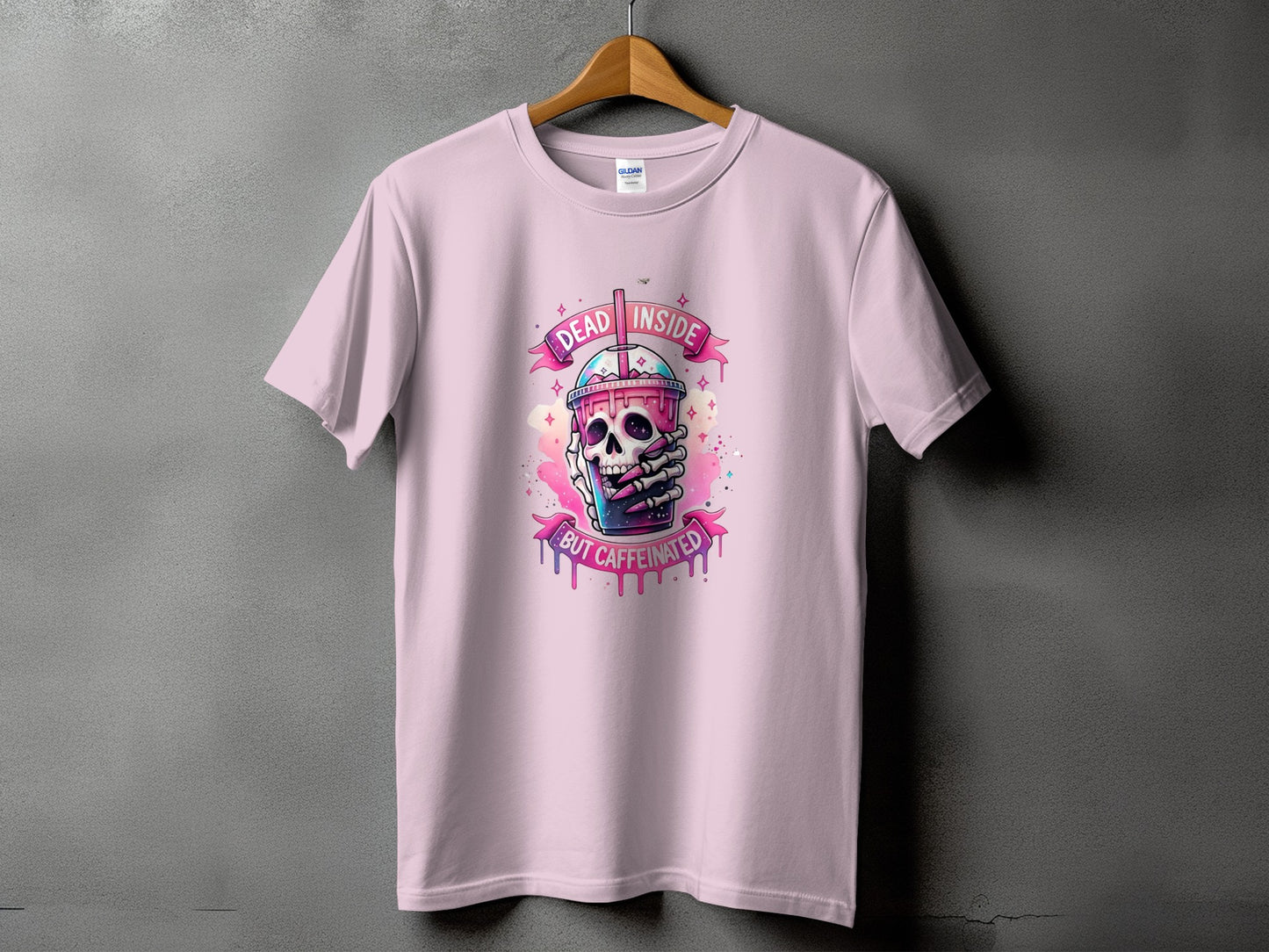 Pink t-shirt with skull and coffee cup graphic saying "Dead Inside But Caffeinated".