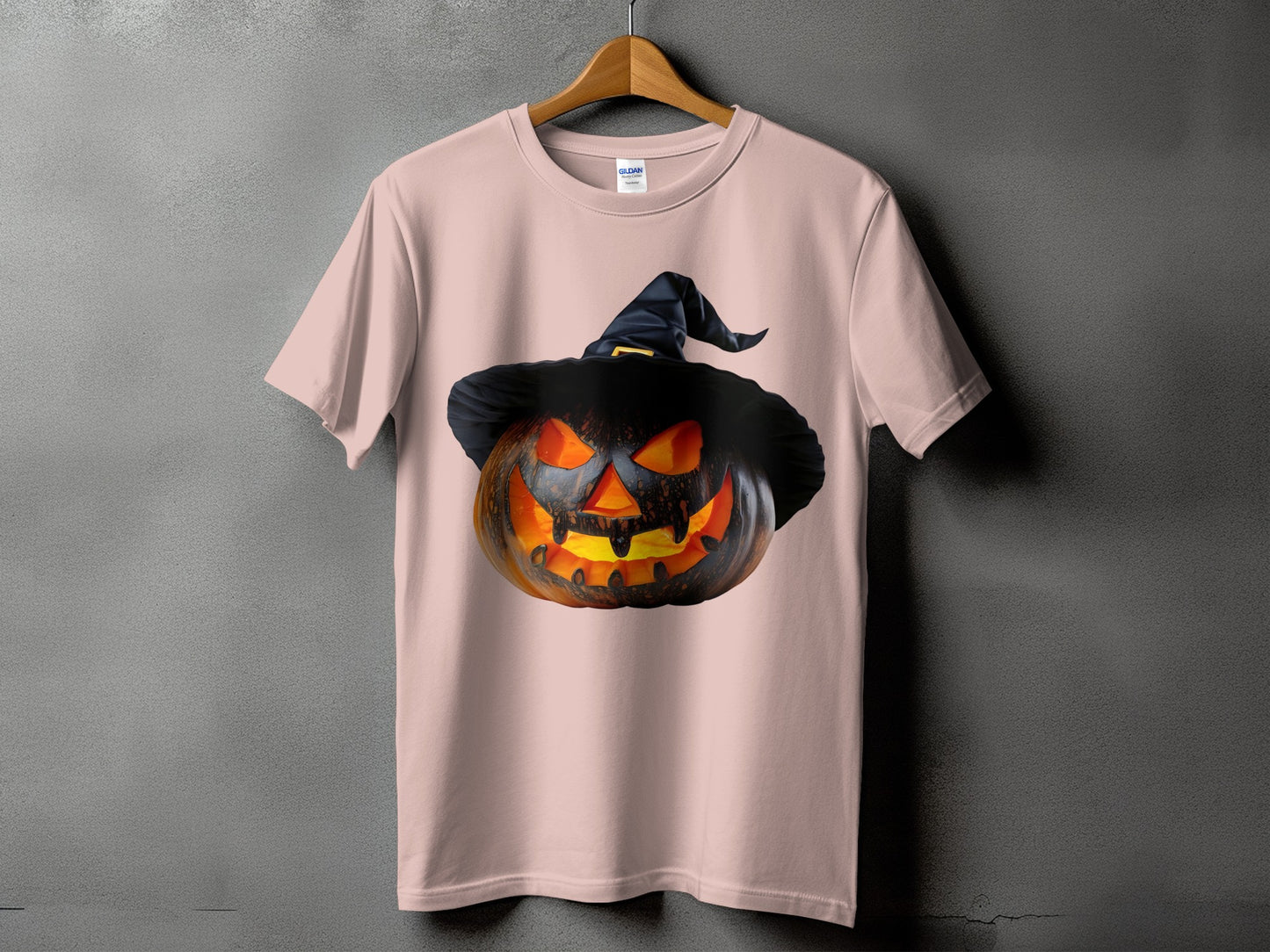 Pink t-shirt with a jack-o'-lantern wearing a black witch hat.