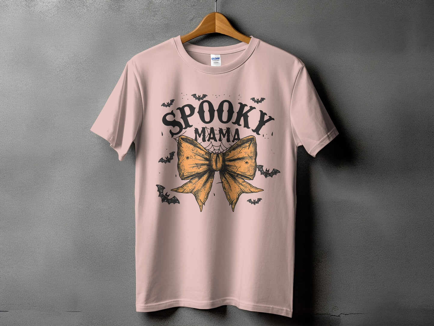 Pink t-shirt with "Spooky Mama" text and Halloween bat graphics.