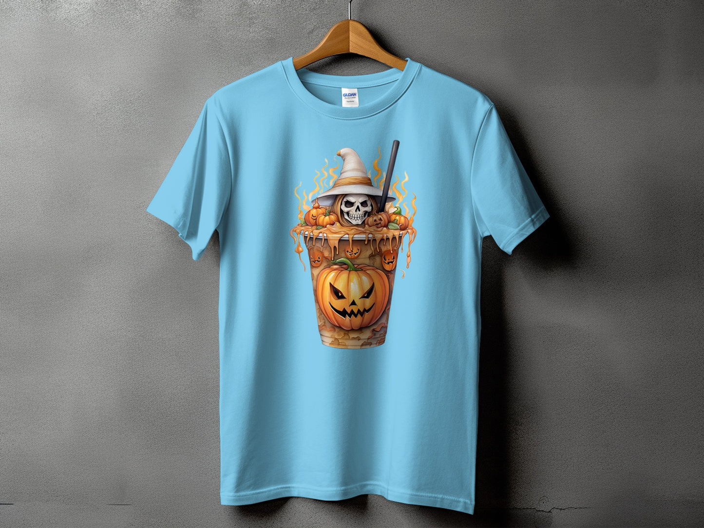 Light blue t-shirt with a Halloween graphic of a skull in a witch hat with pumpkins.