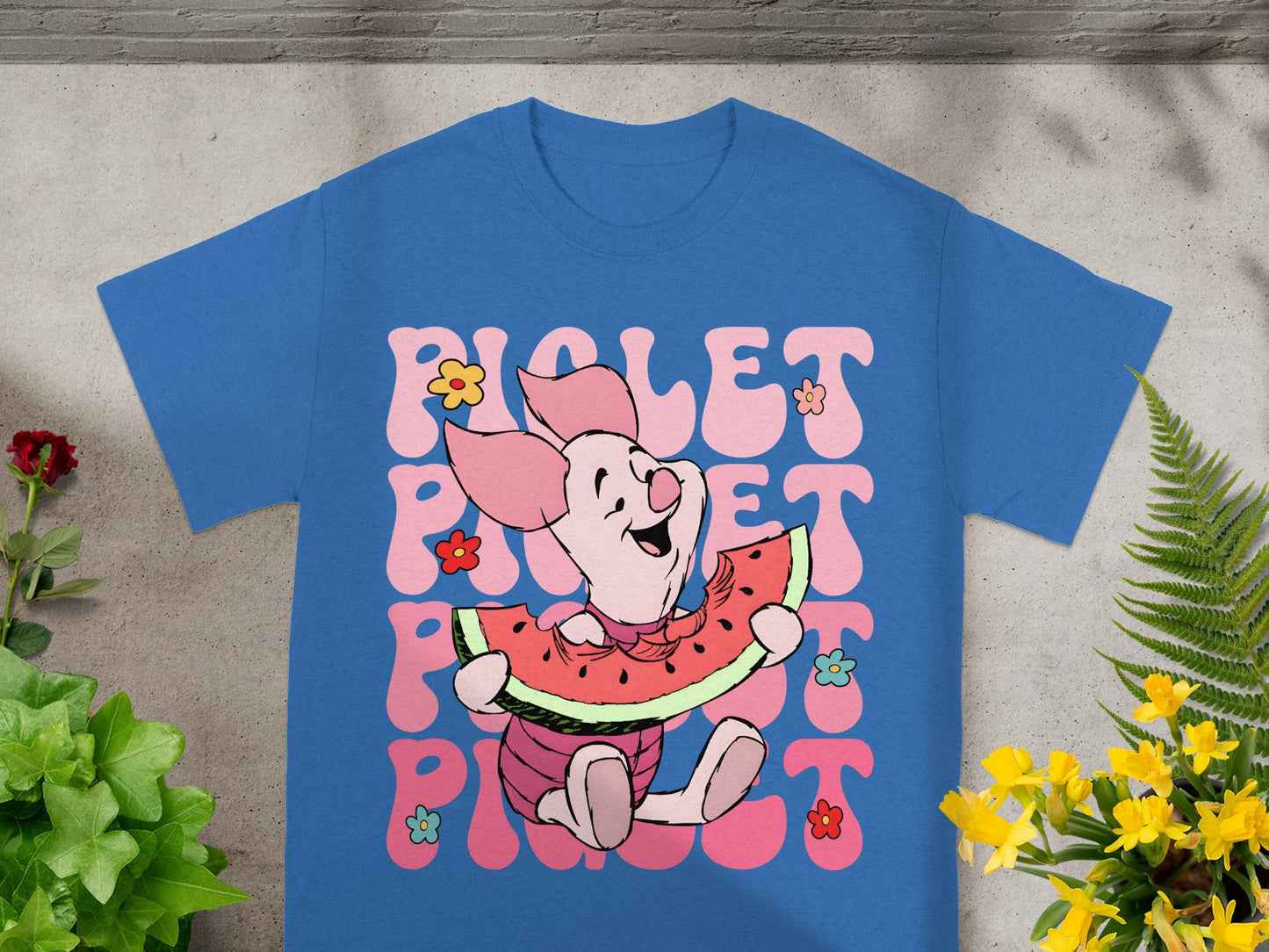 Piglet eating watermelon on blue t-shirt with "Piglet" text.