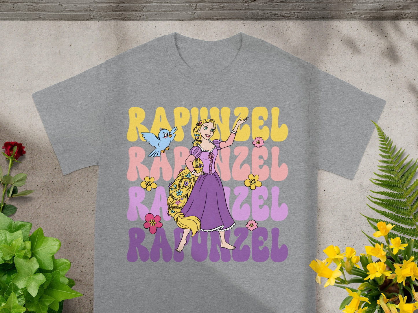 Rapunzel graphic tee with pastel lettering and a bird.