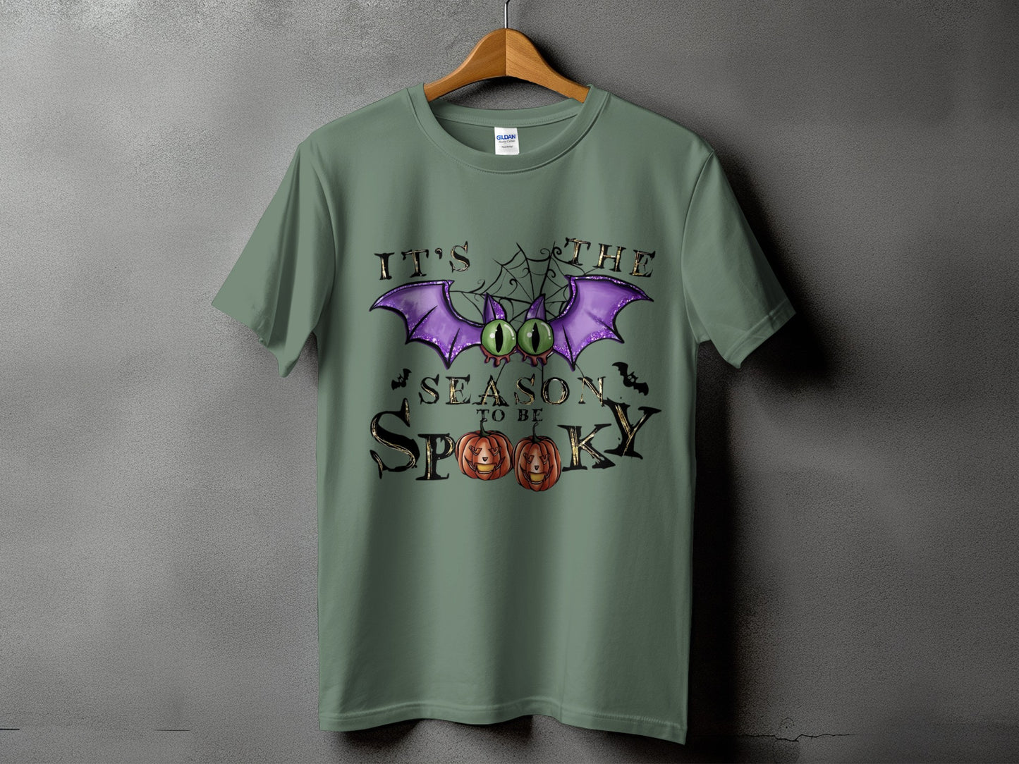 Green t-shirt with "It's the season to be spooky" Halloween graphic.