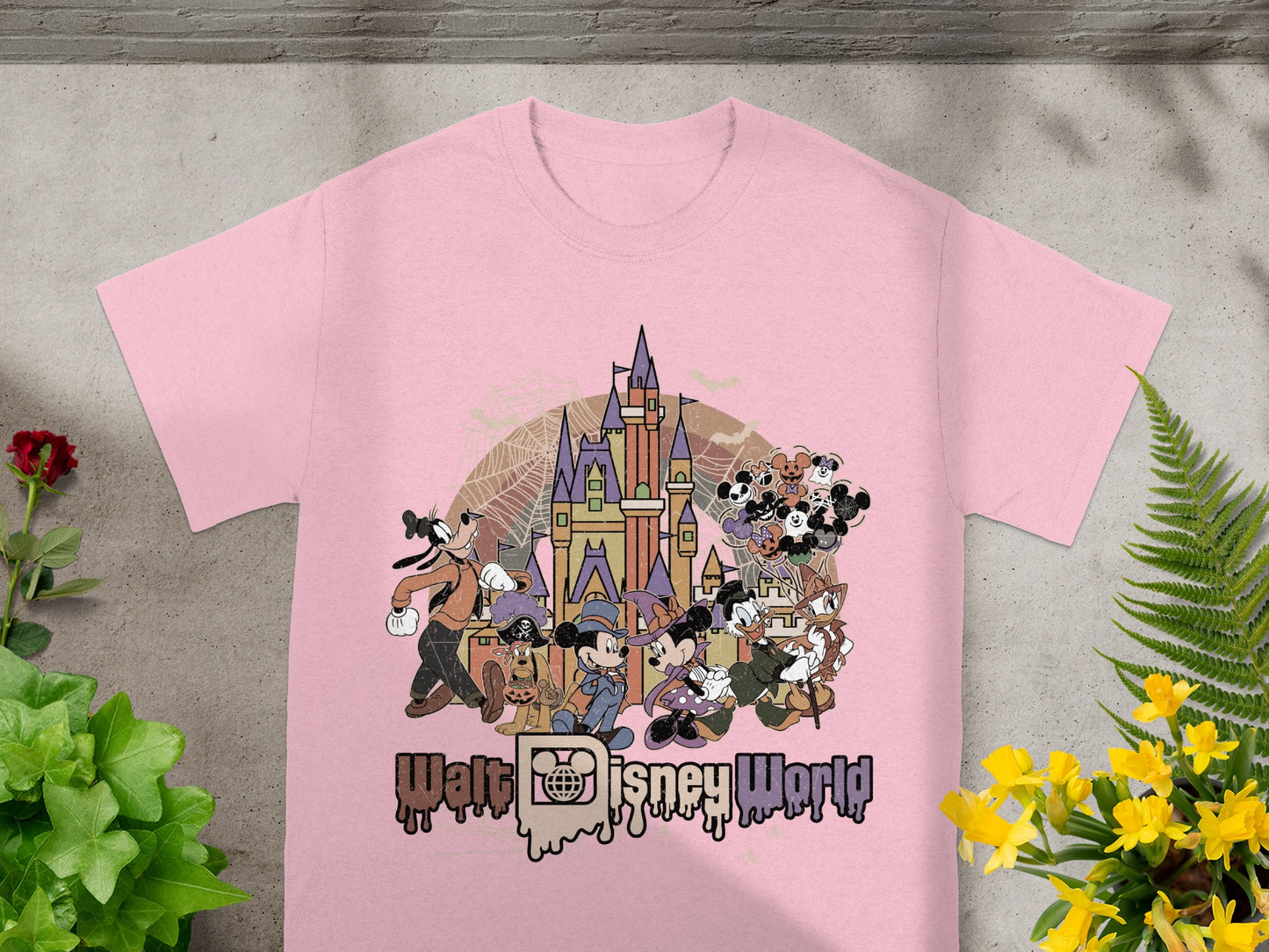 Pink t-shirt with vintage Walt Disney World Halloween characters and castle graphic.