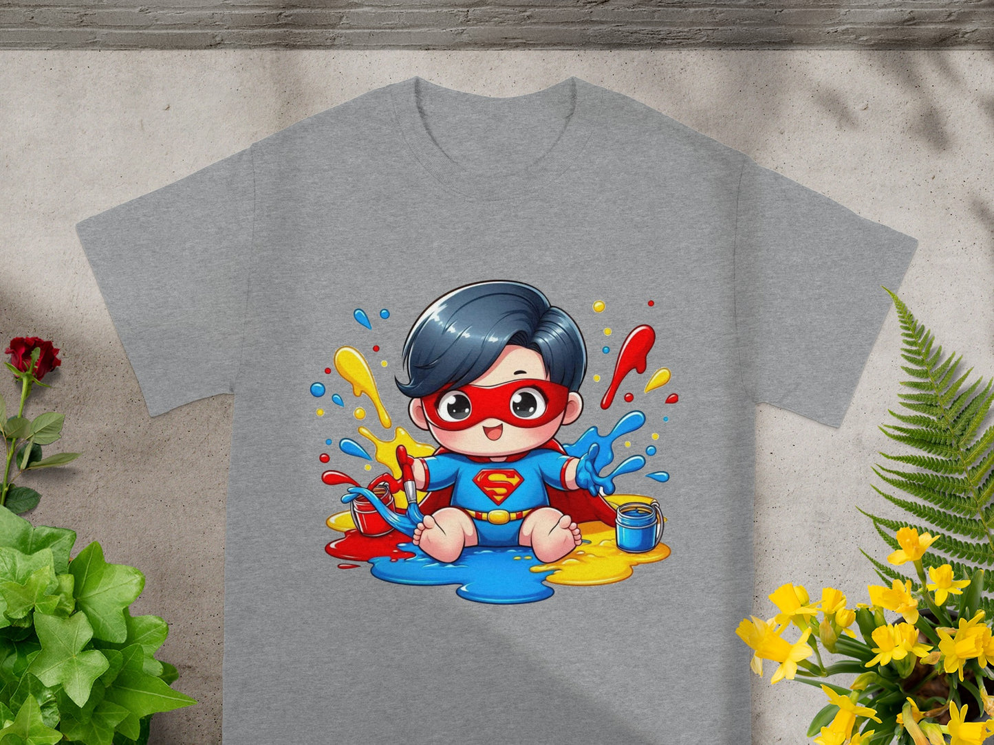 Superhero kid with paint splatters on a gray t-shirt.