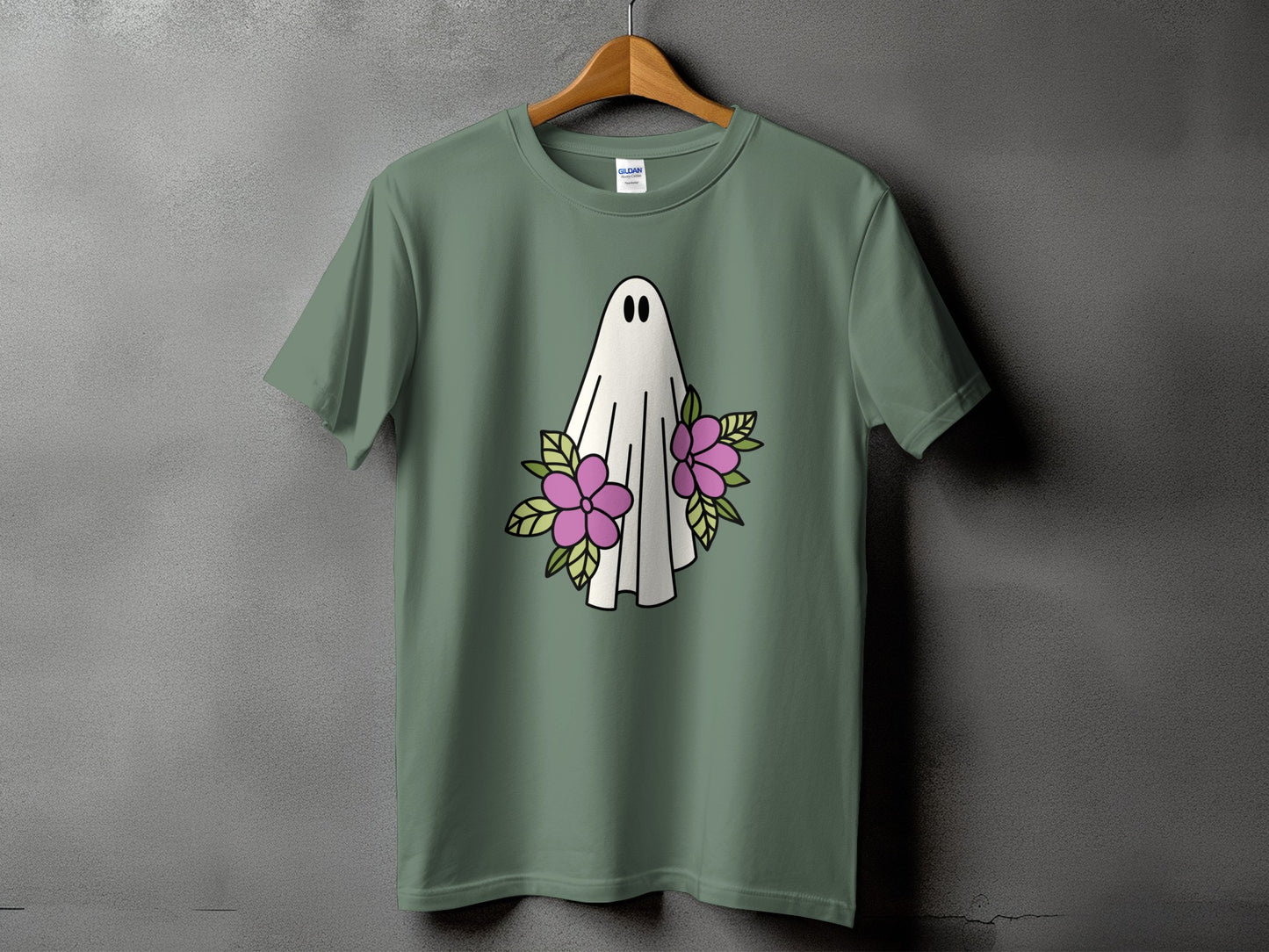 Green t-shirt with a white ghost and pink flowers graphic.