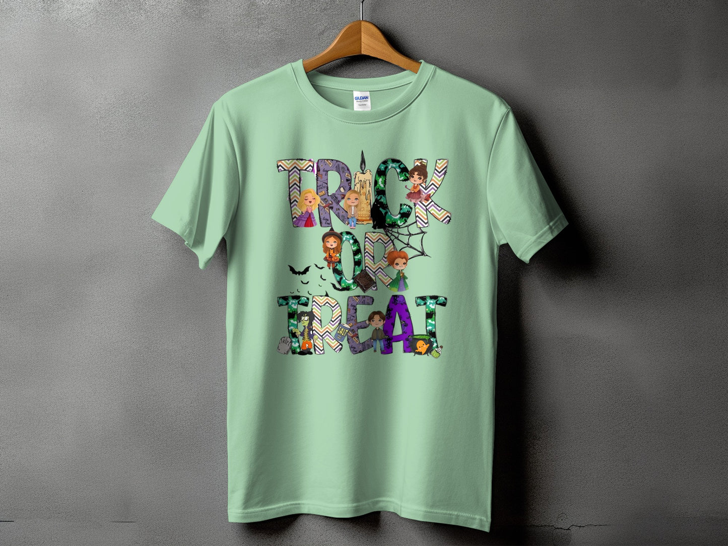Light green t-shirt with "Trick or Treat" text and Halloween-themed cartoon characters.