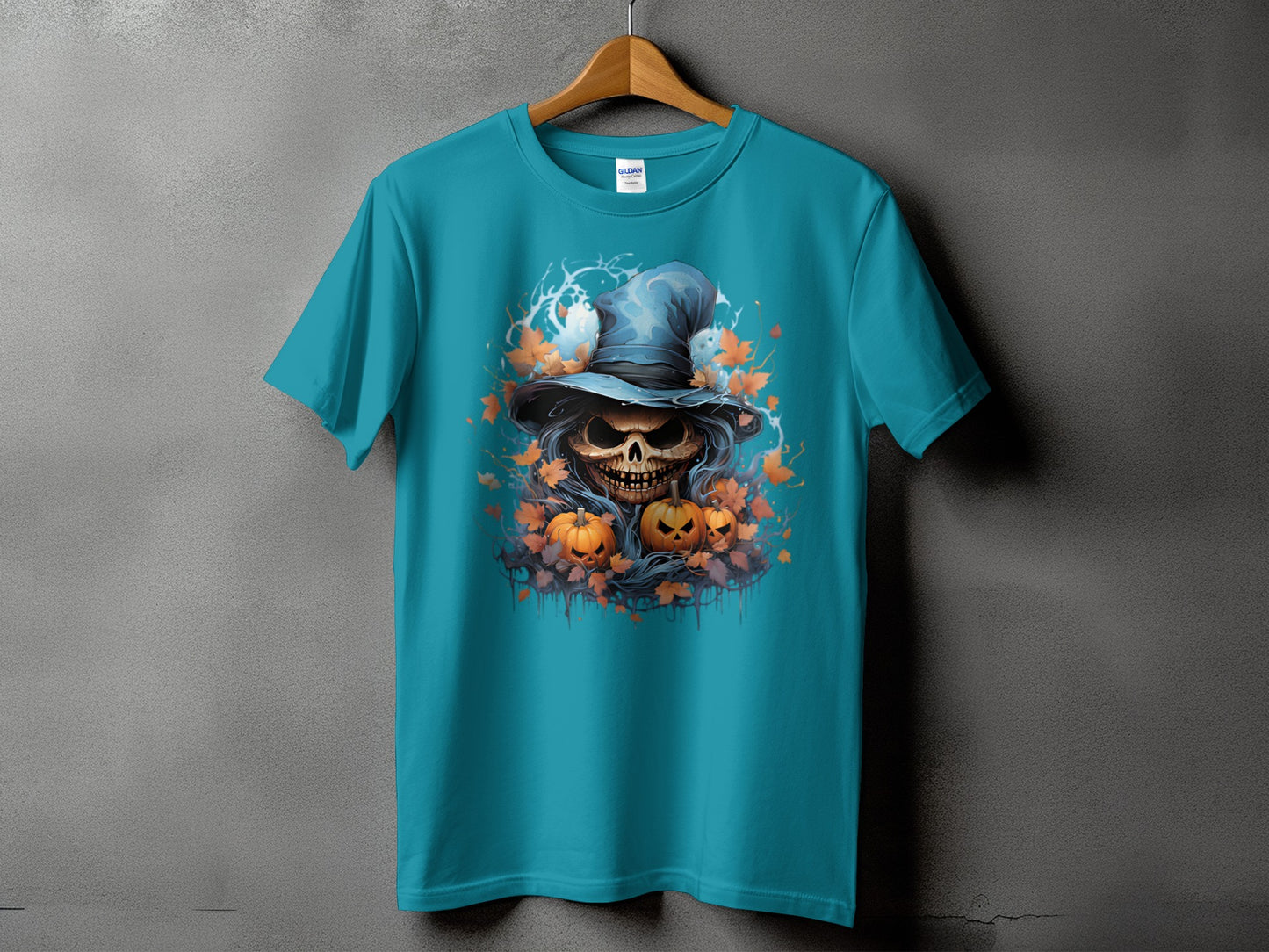 Teal t-shirt with Halloween skull, pumpkins, and falling leaves graphic.
